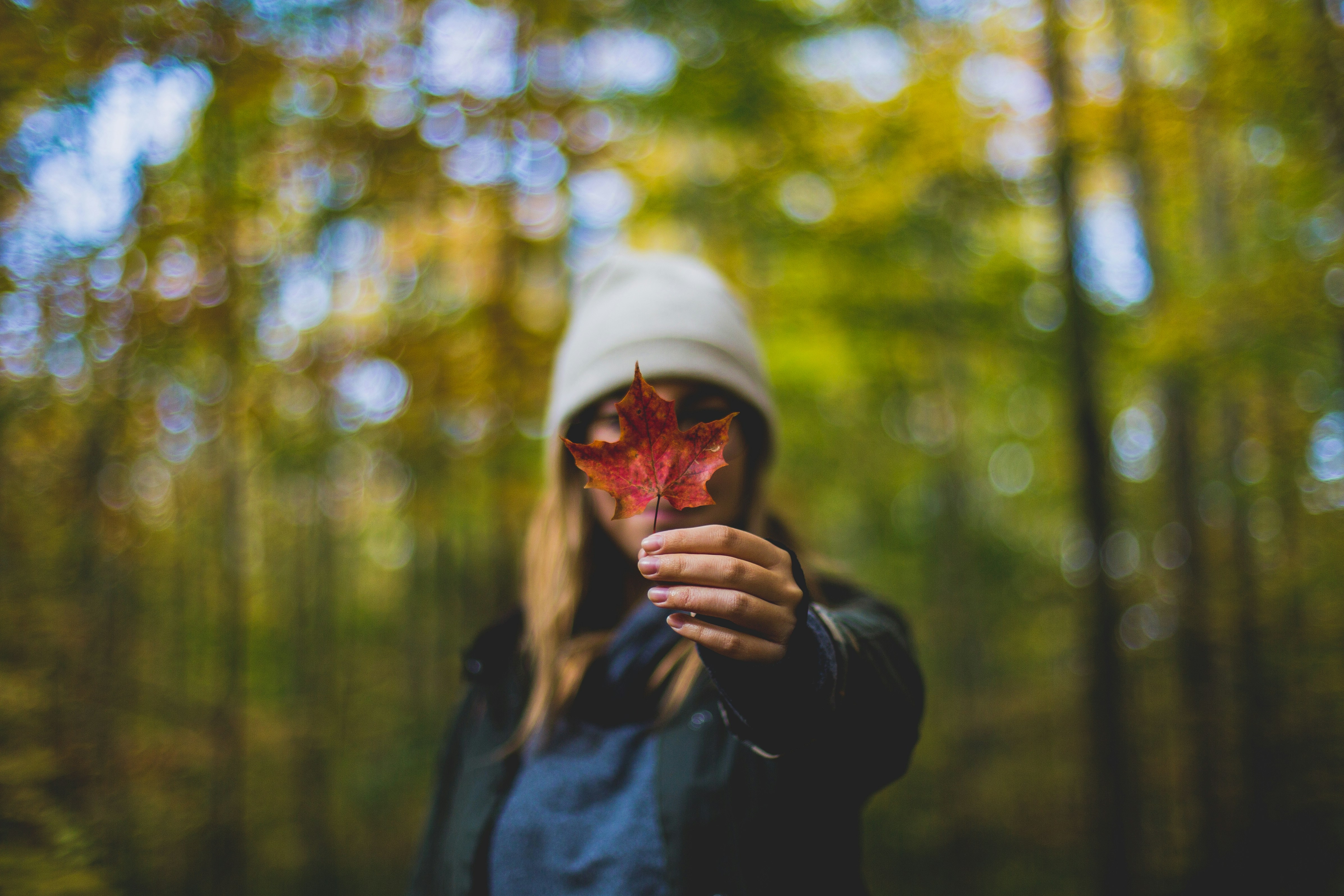 woman holding an autumn leaf - Deep Autumn Color Analysis