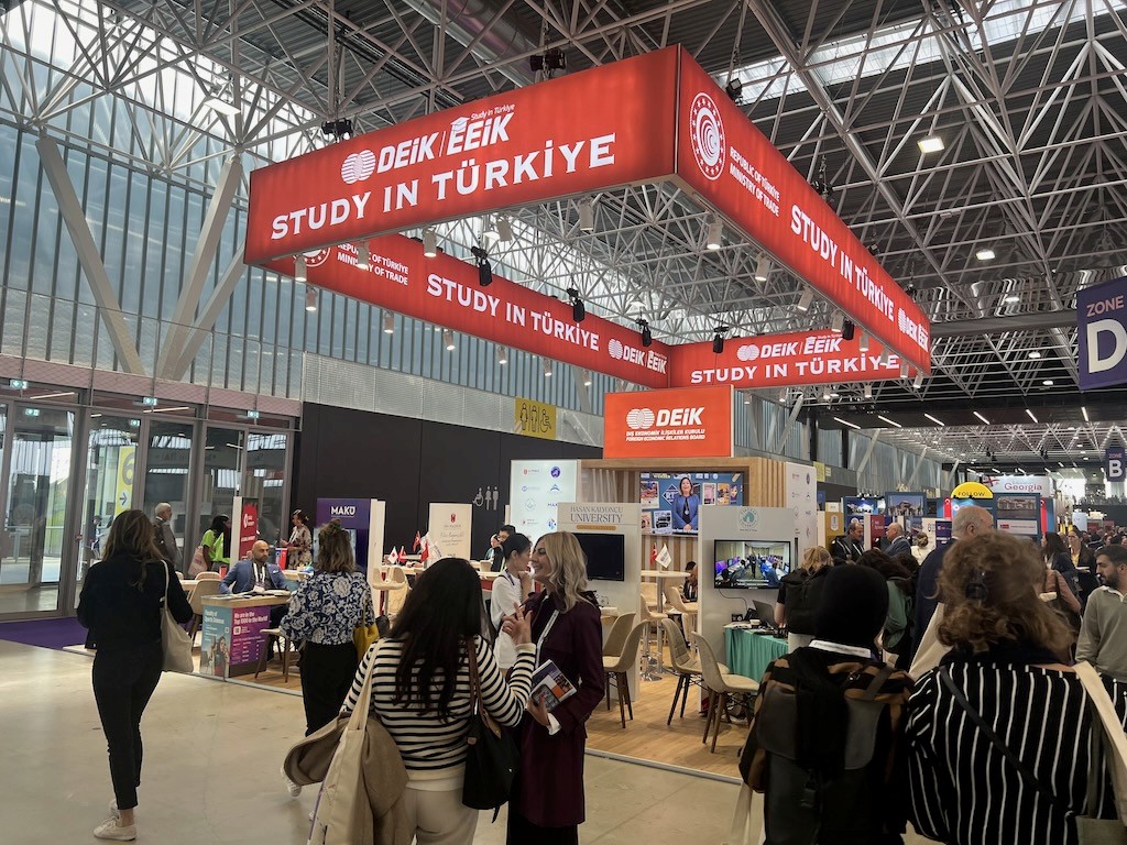 Large ceiling‑hung banner suspended over the DEİK Study in Türkiye pavilion, creating a dramatic entry point and strong brand presence.