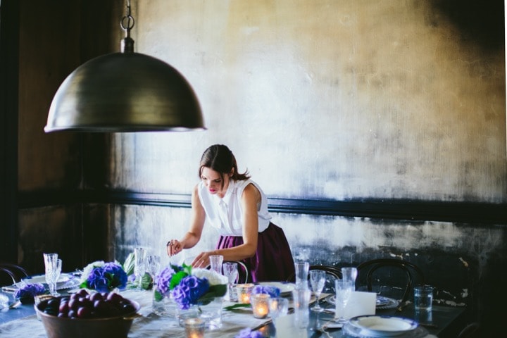 Stylist setting up table setting