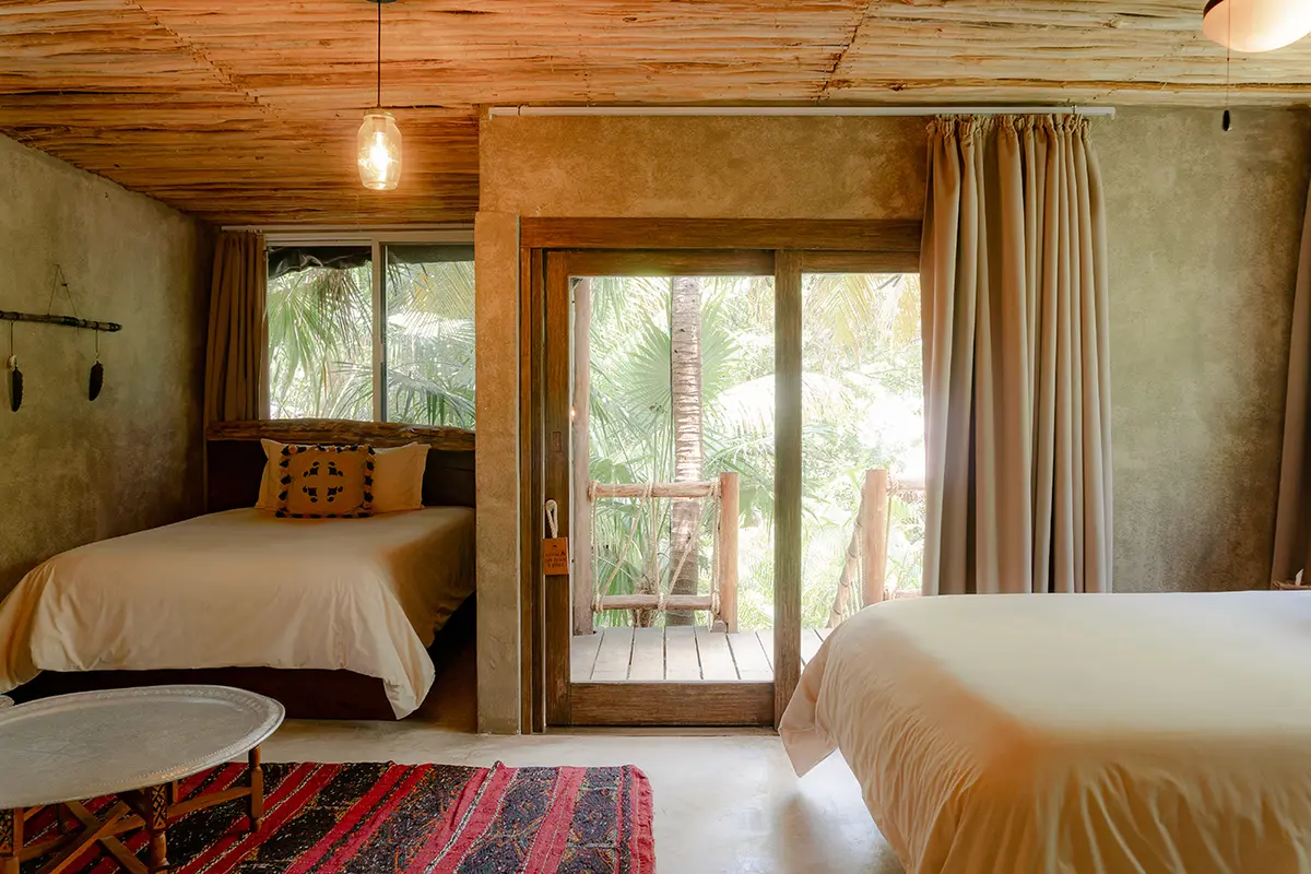 Oceanfront Room at Nômade Tulum featuring outdoor seating area with cabana-style shade and direct ocean view.