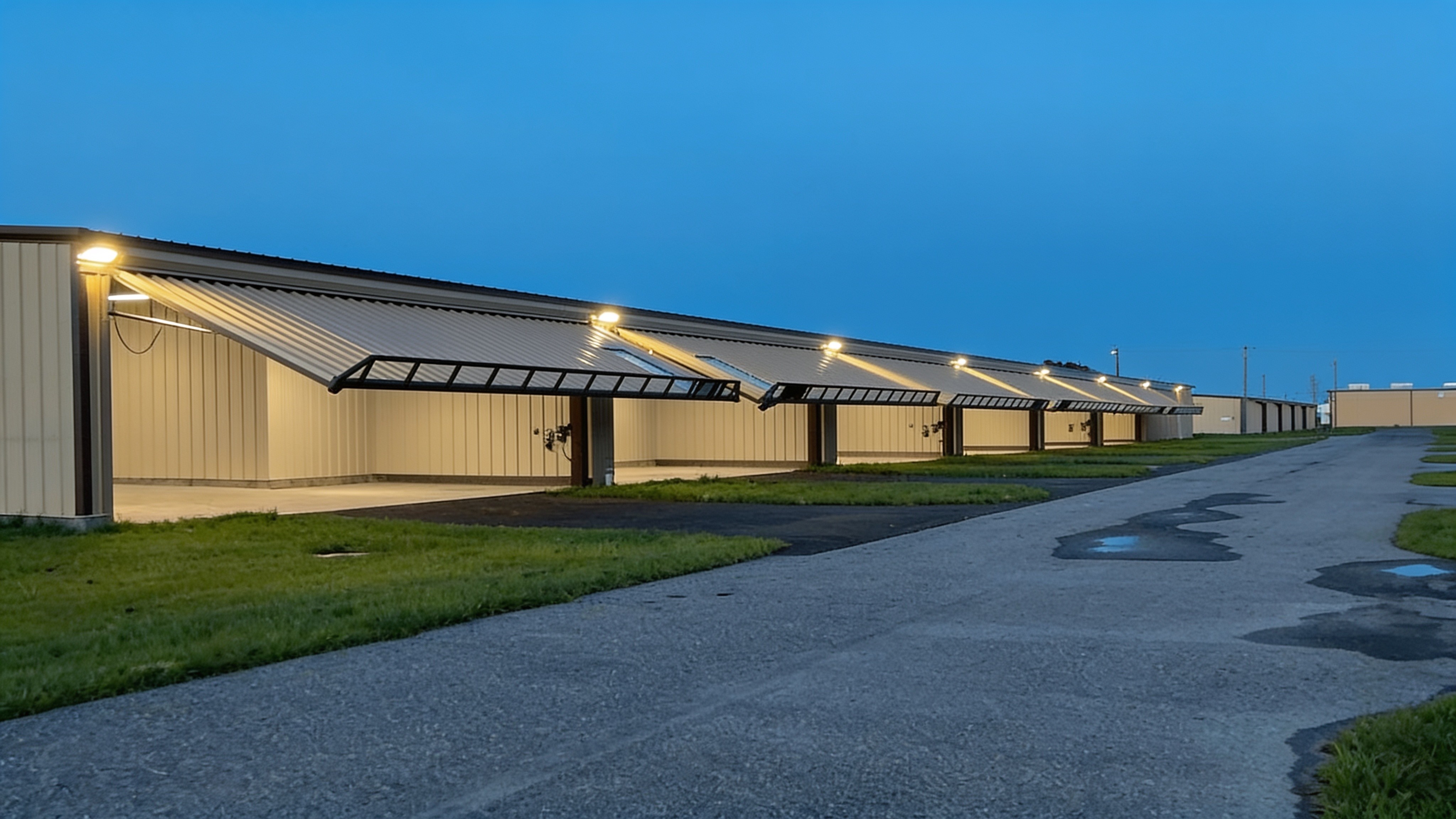 Aircraft hangar with an open hydraulic door at twilight