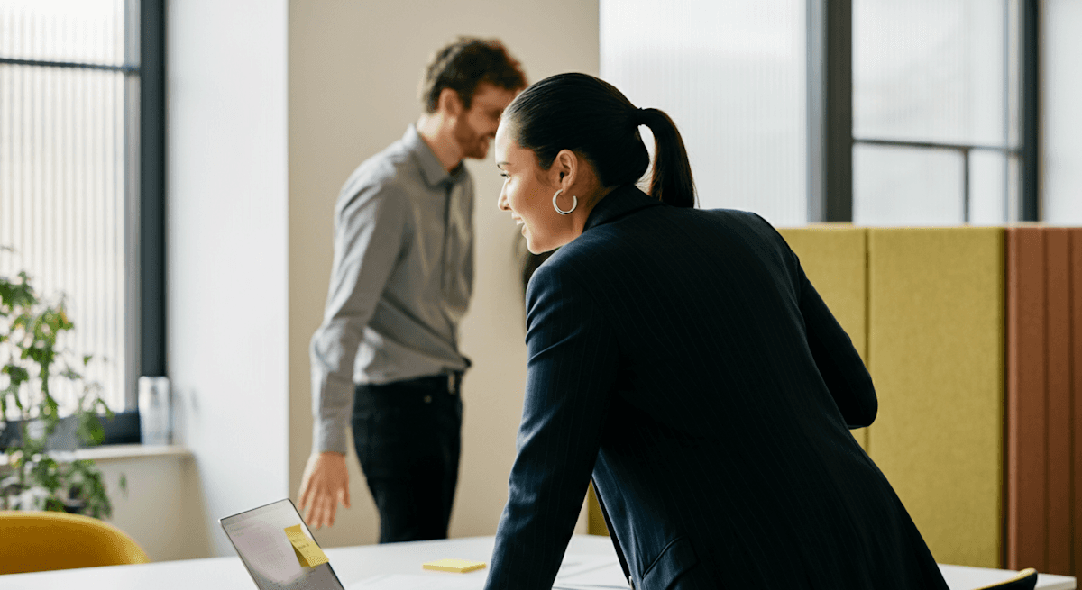 AI automation platform showcasing team collaboration with professionals discussing work in a modern office setting.