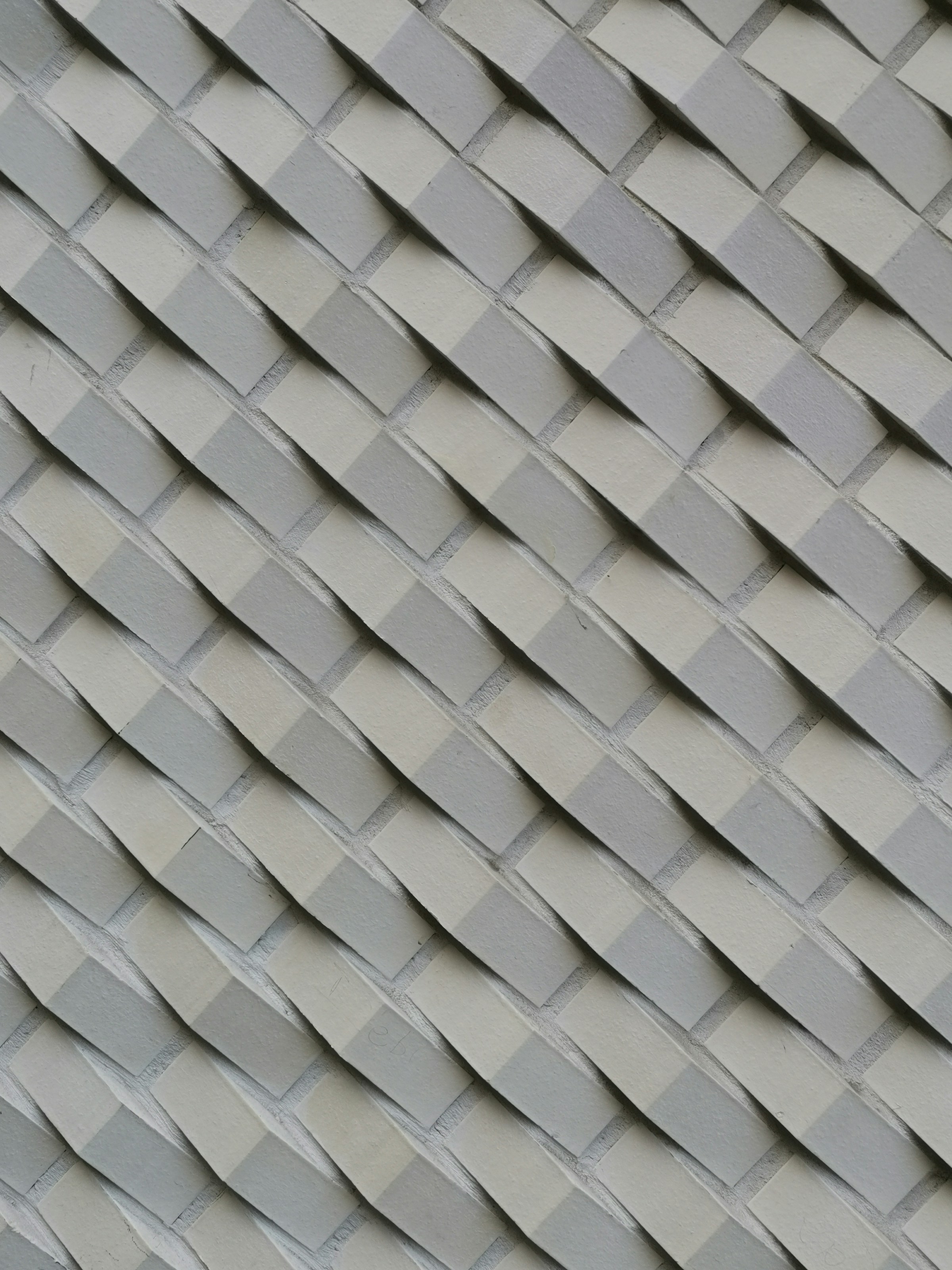 Textured gray and cream diagonal bricks