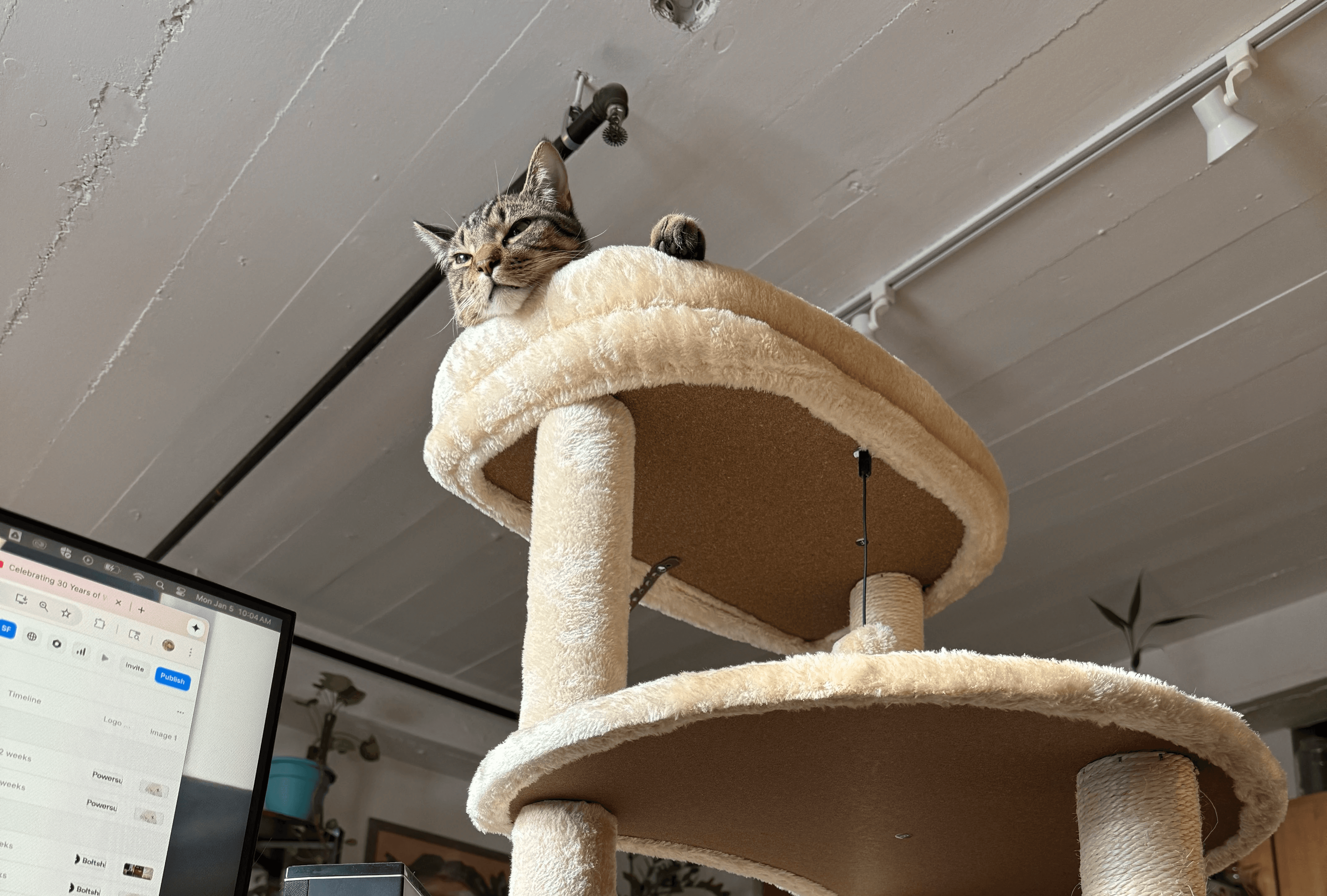 A large group photo of diverse team members gathered in an industrial-style space with arched ceiling.