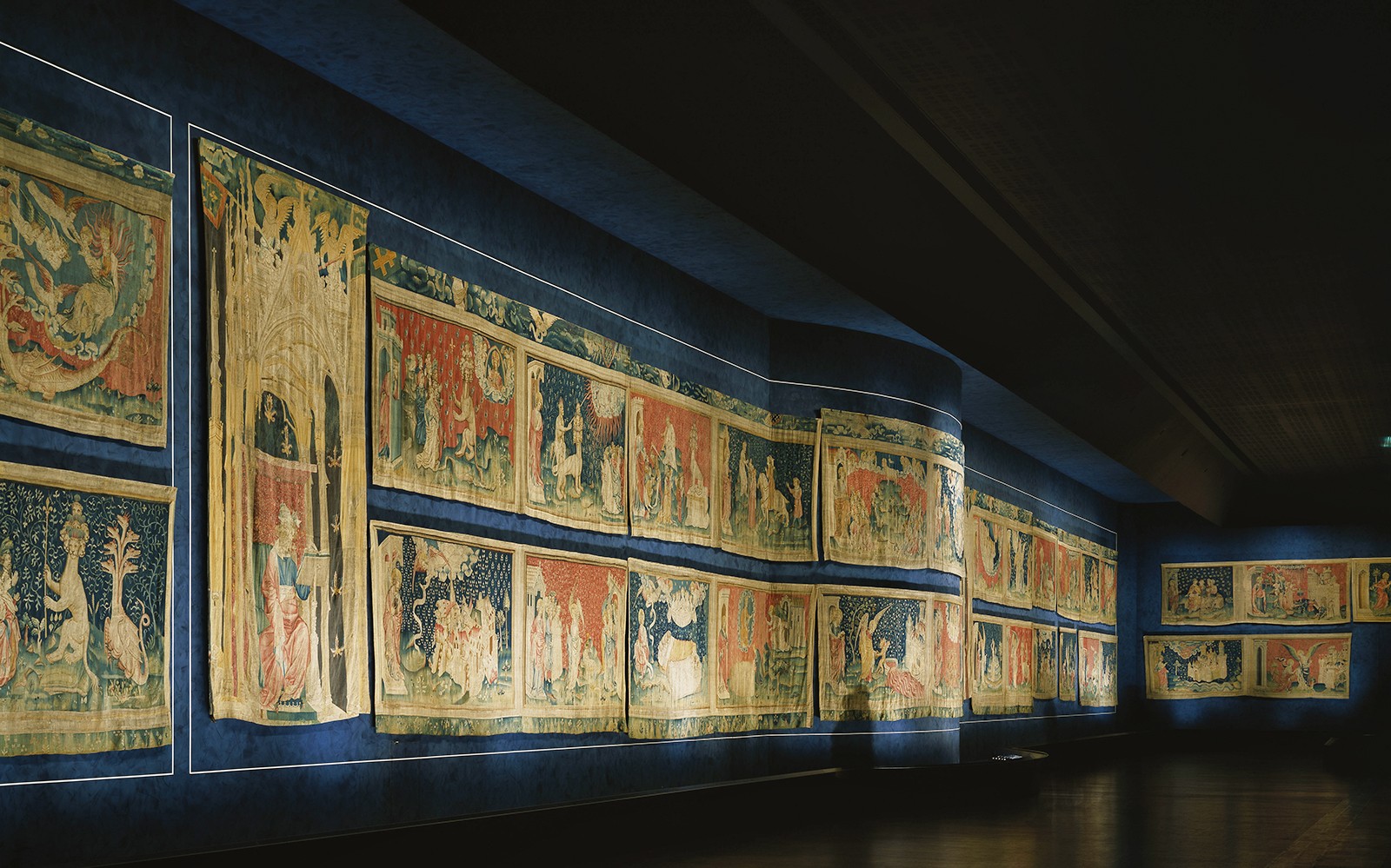 Tapestries displayed inside Angers Castle, depicting historical scenes.