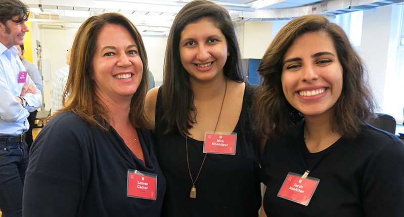 three women in black top smiling