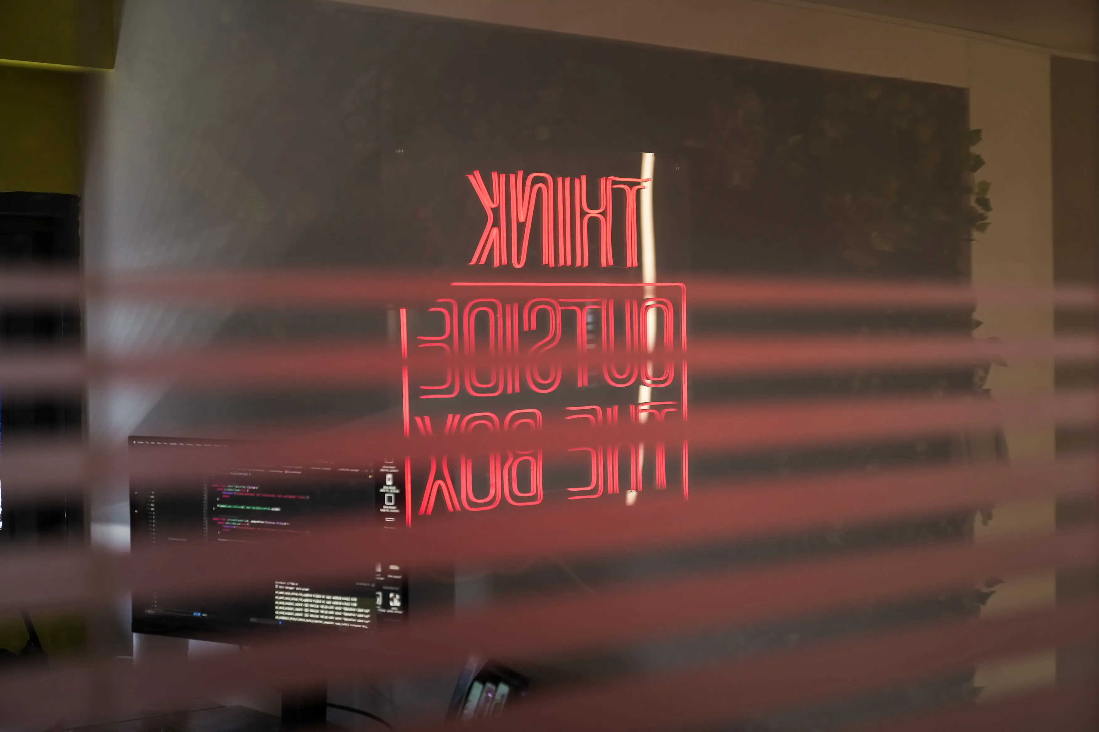Neon sign displaying the words ‘Think Outside the Box’ inside the Neon Apps office.