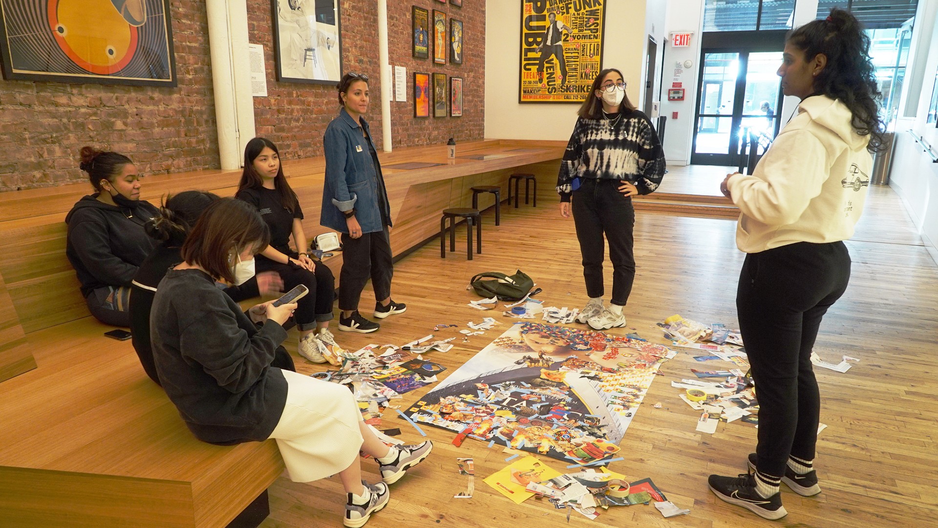 Maya Varadaraj giving a tour of Poster House museum to students