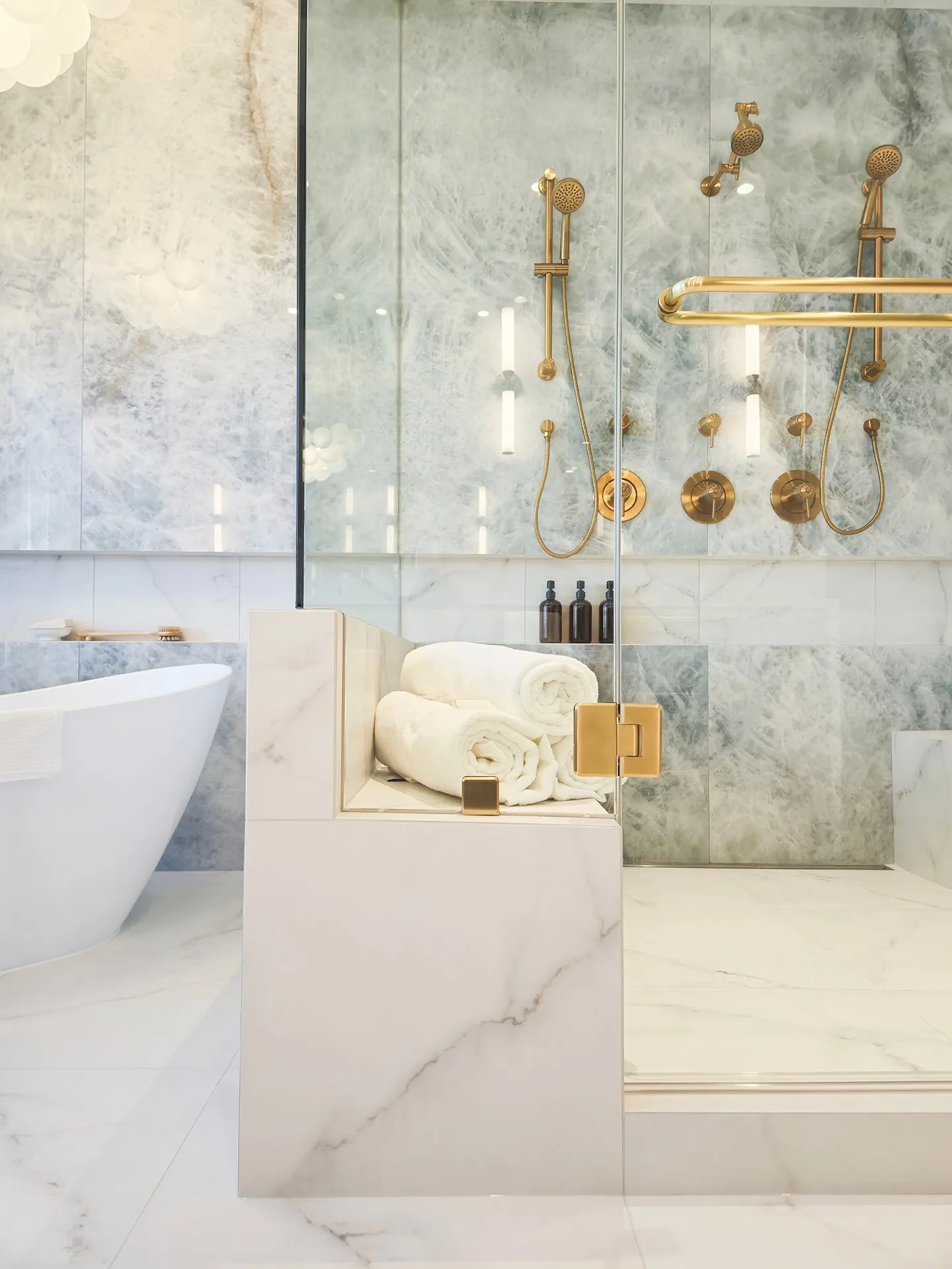 Image of luxurious steam shower with cloudy blue large format tile.
