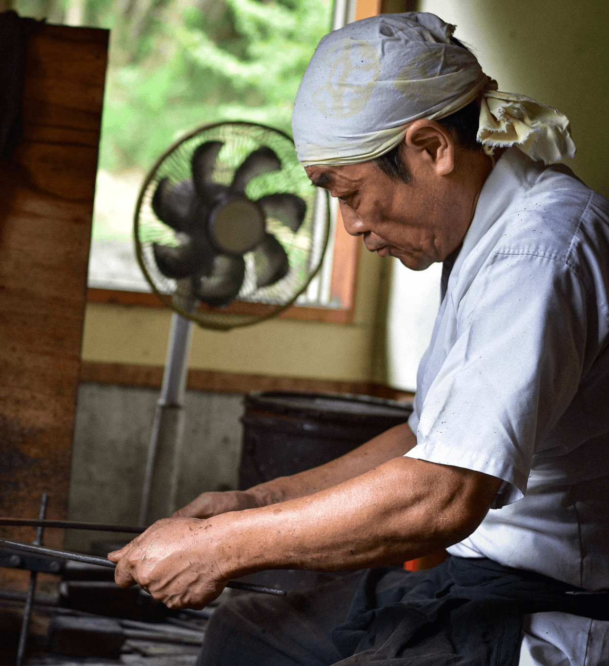 Swordsmiths hammering iron in a team