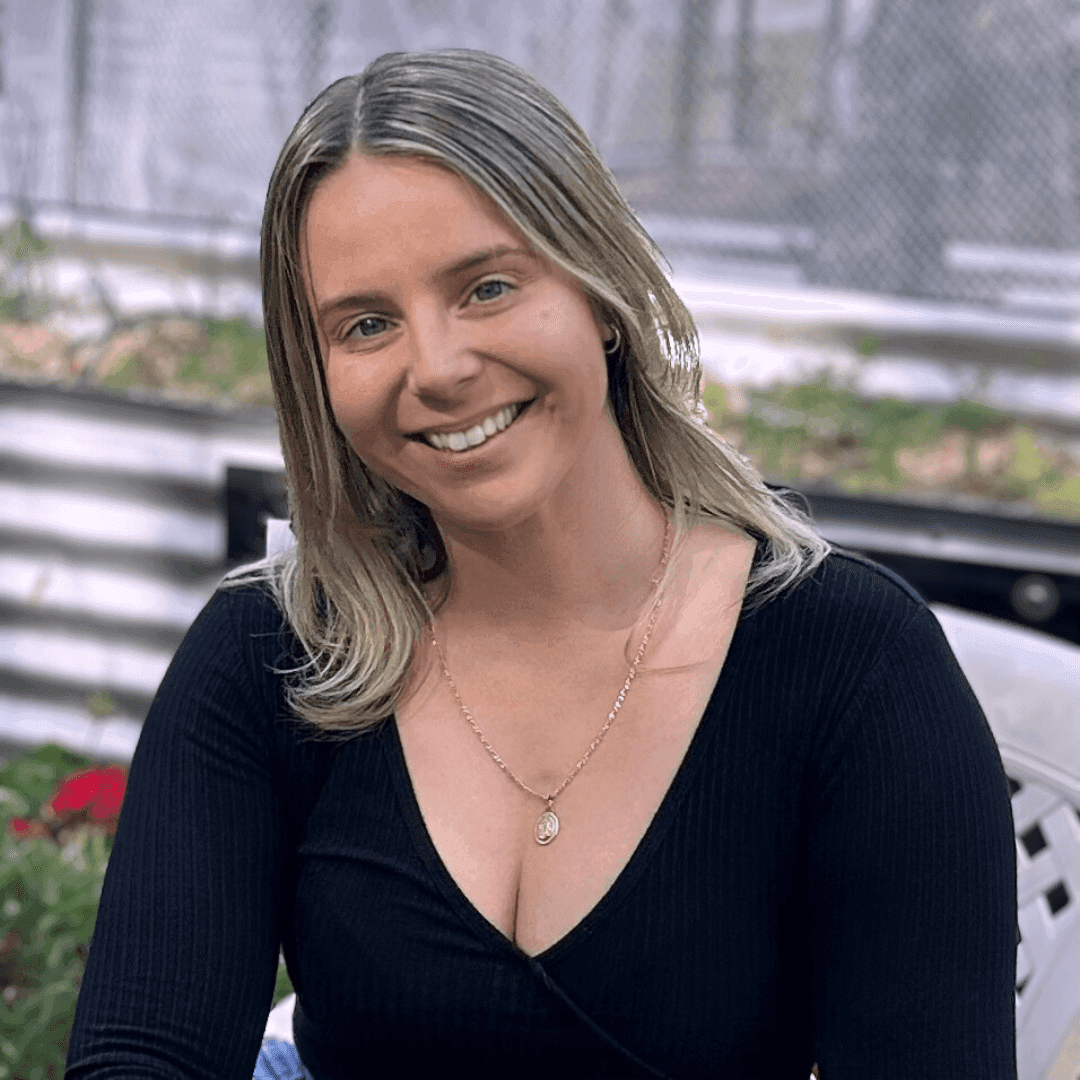 Professional photo of a health practitioner against a background with green plants