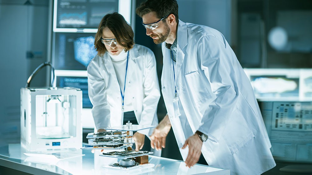 Team von Ingenieuren im High-Tech-Labor entwickelt IoT-Gerät, moderne Technik und Zusammenarbeit in Medizintechnik.