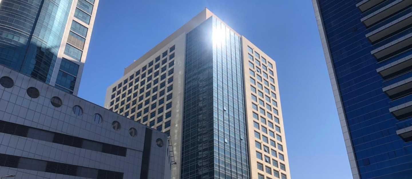 Sunlight reflecting off the glass windows of Grosvenor Business Tower, a top-tier choice for corporate headquarters.