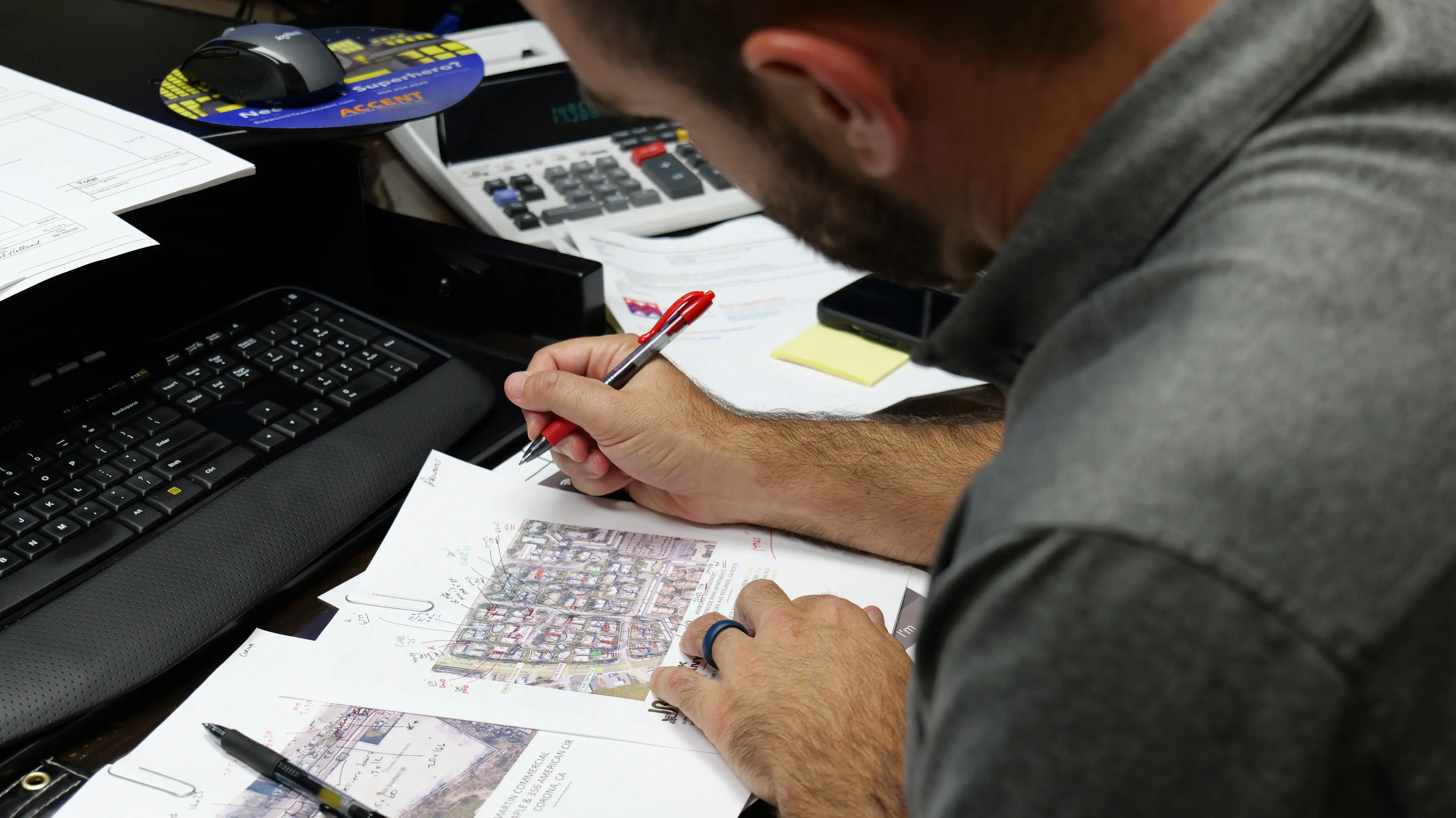 Man concentrating writing notes on paper on desk