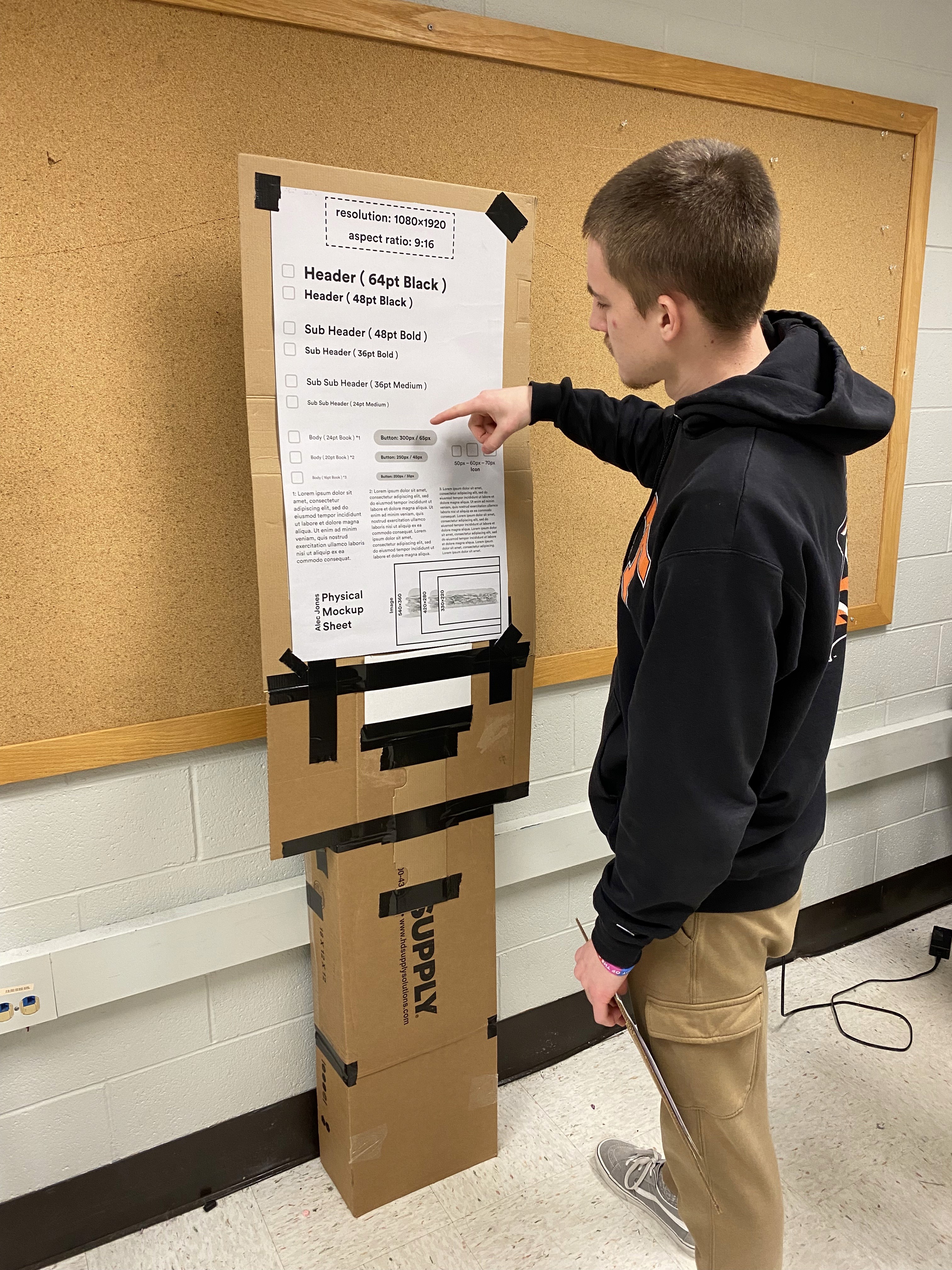 Person using the physical mockup to test physical measurements.