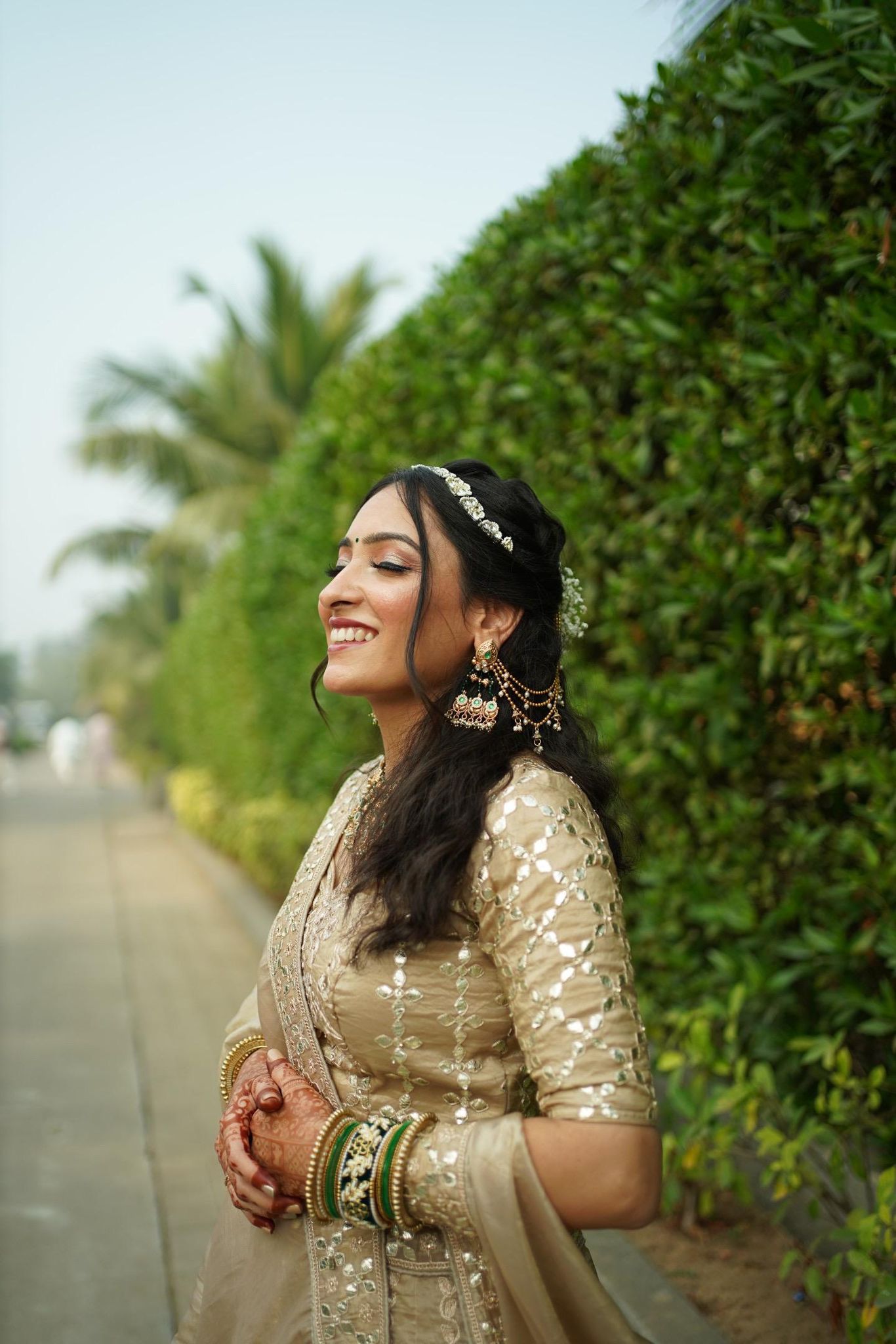 Beautiful girl standing near tree foliage