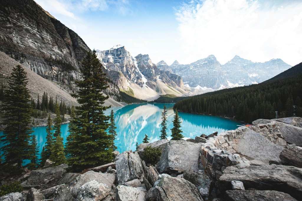 A lake surrounded by trees and mountains