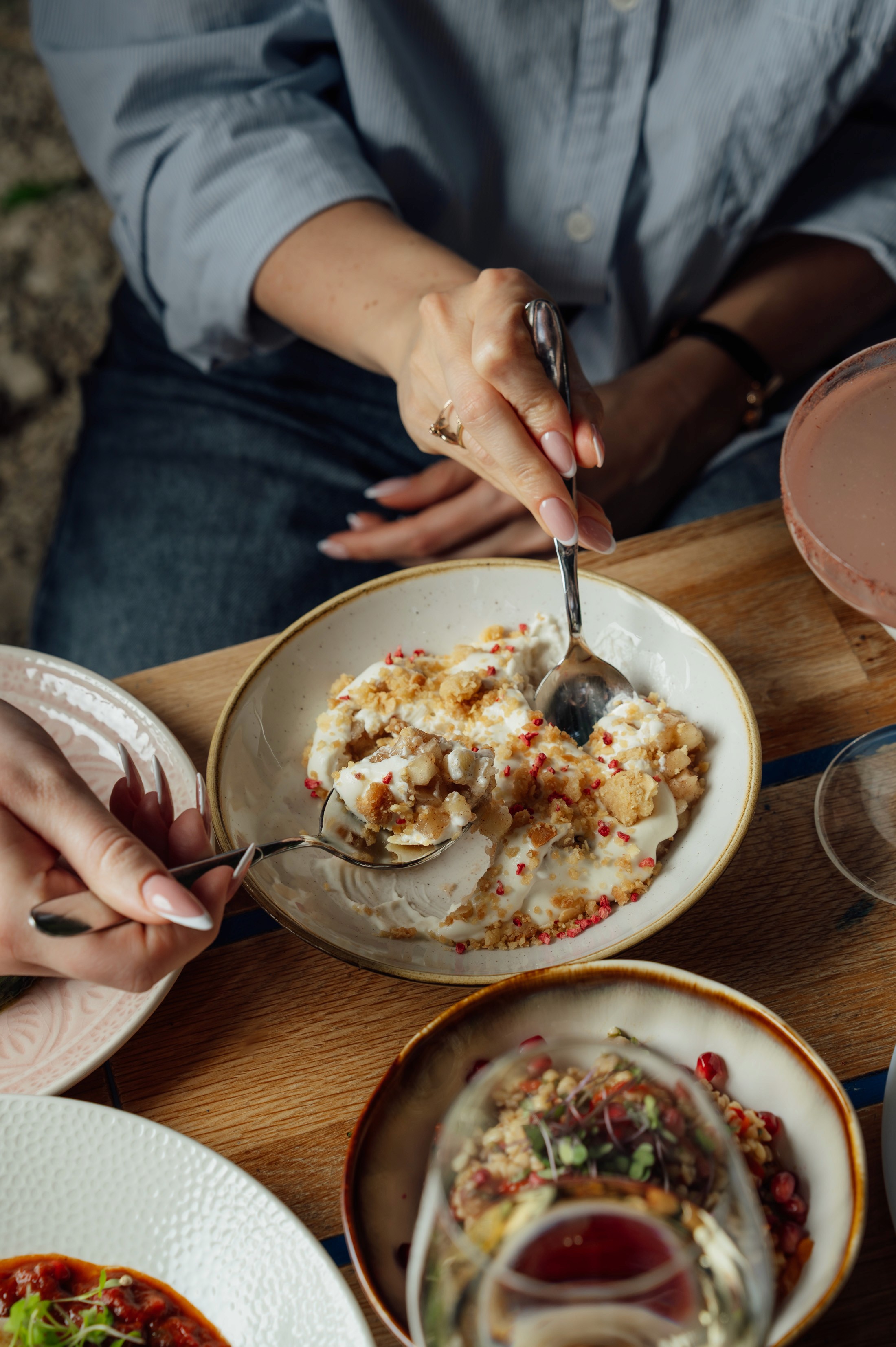 People sharing food at Mazeltov restaurant