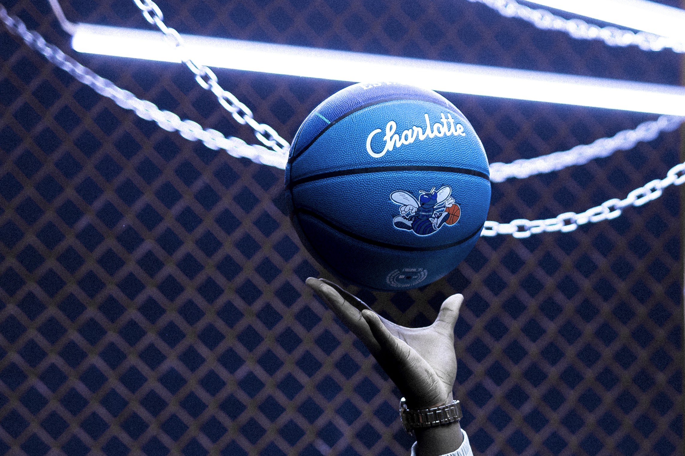 Clifford Taylor IV  holding  new Wilson Charlotte Hornets Basketball during branded campaign shoot in Los Angeles photos taken by Johnny Baru Media