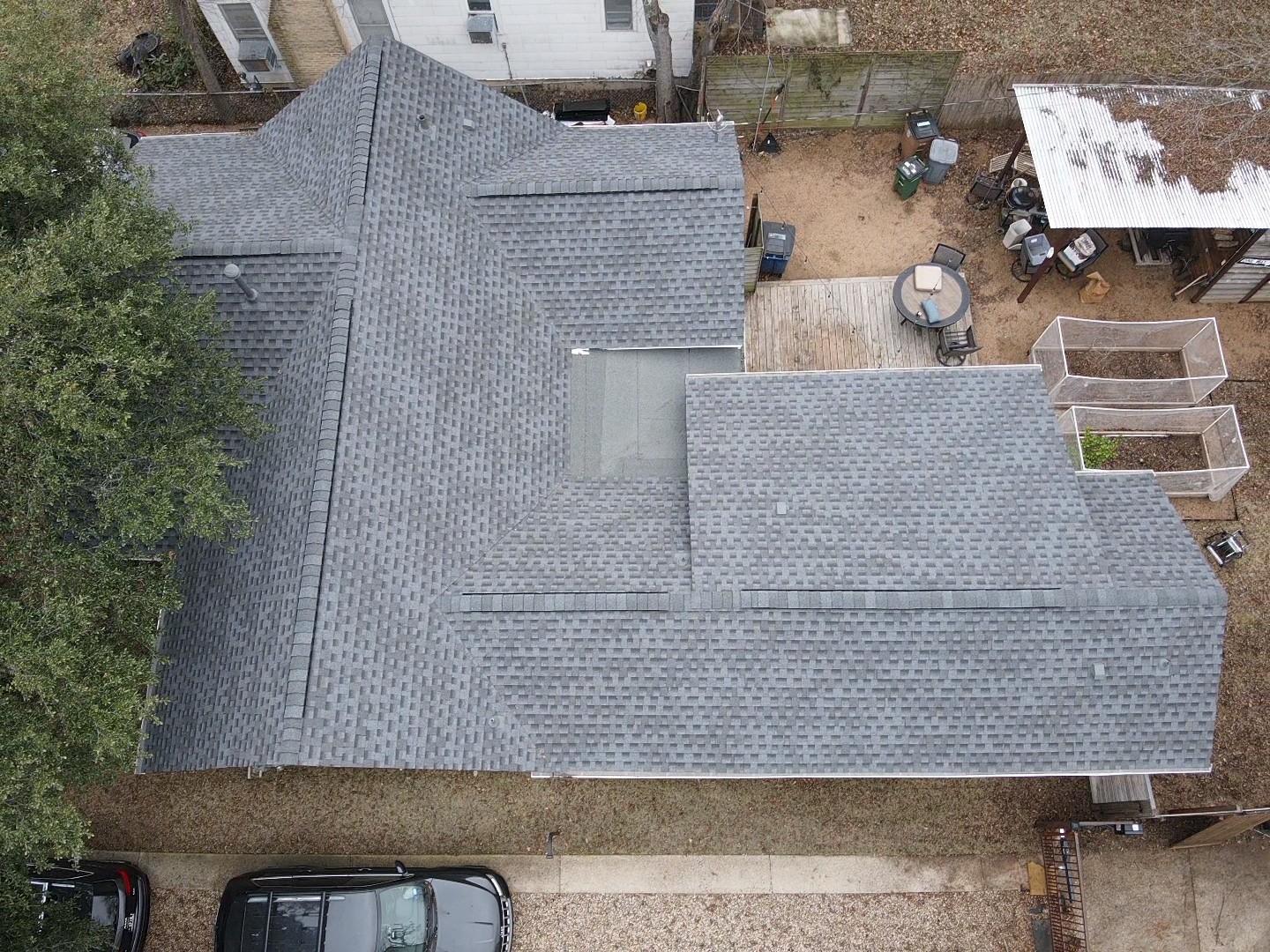 Pewter grey crossed hipped roof with a ridge vent, complemented by a modified bitumen porch and GAF architectural shingles for a stylish and functional design.