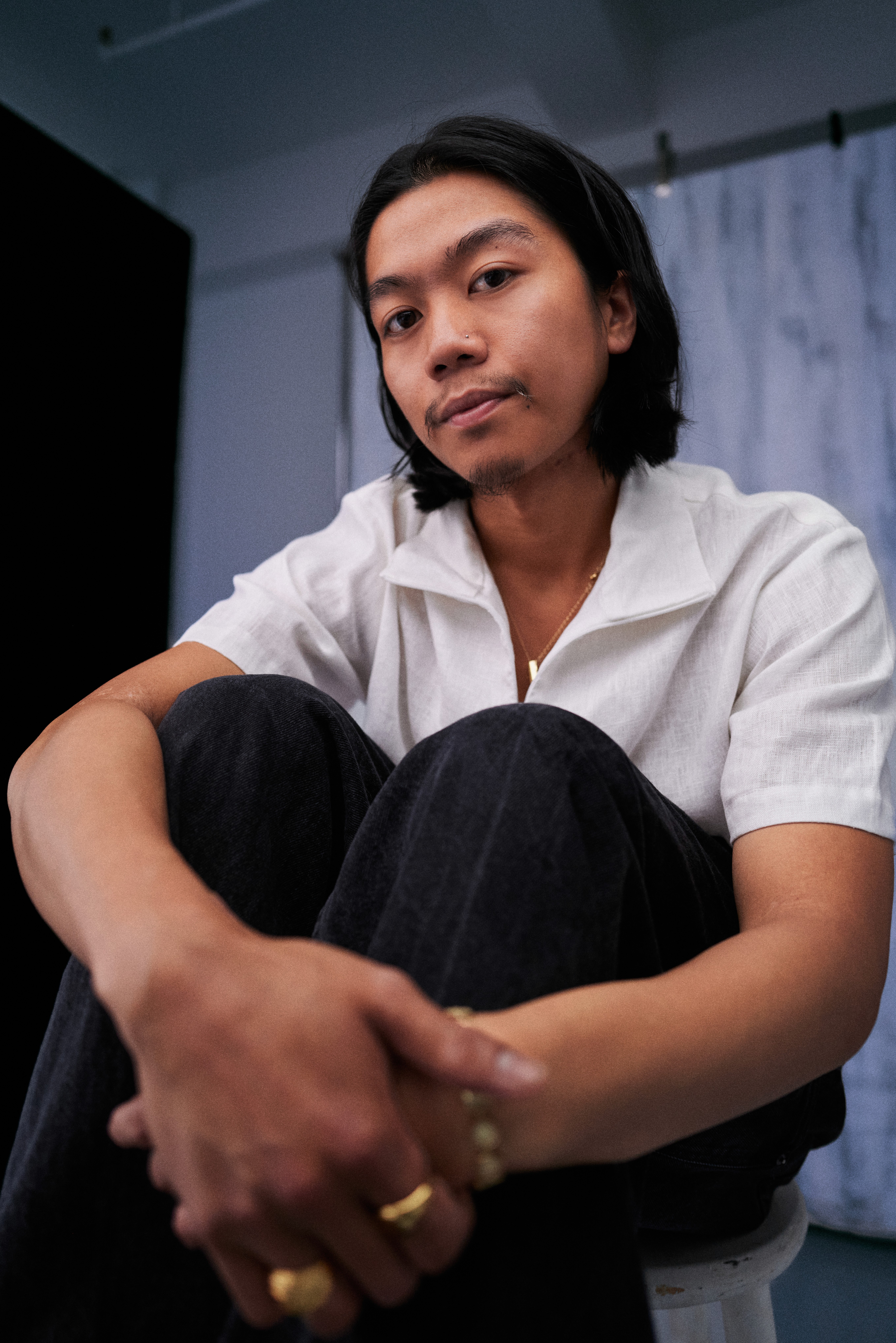 photo of a person sitting in front of a wall
