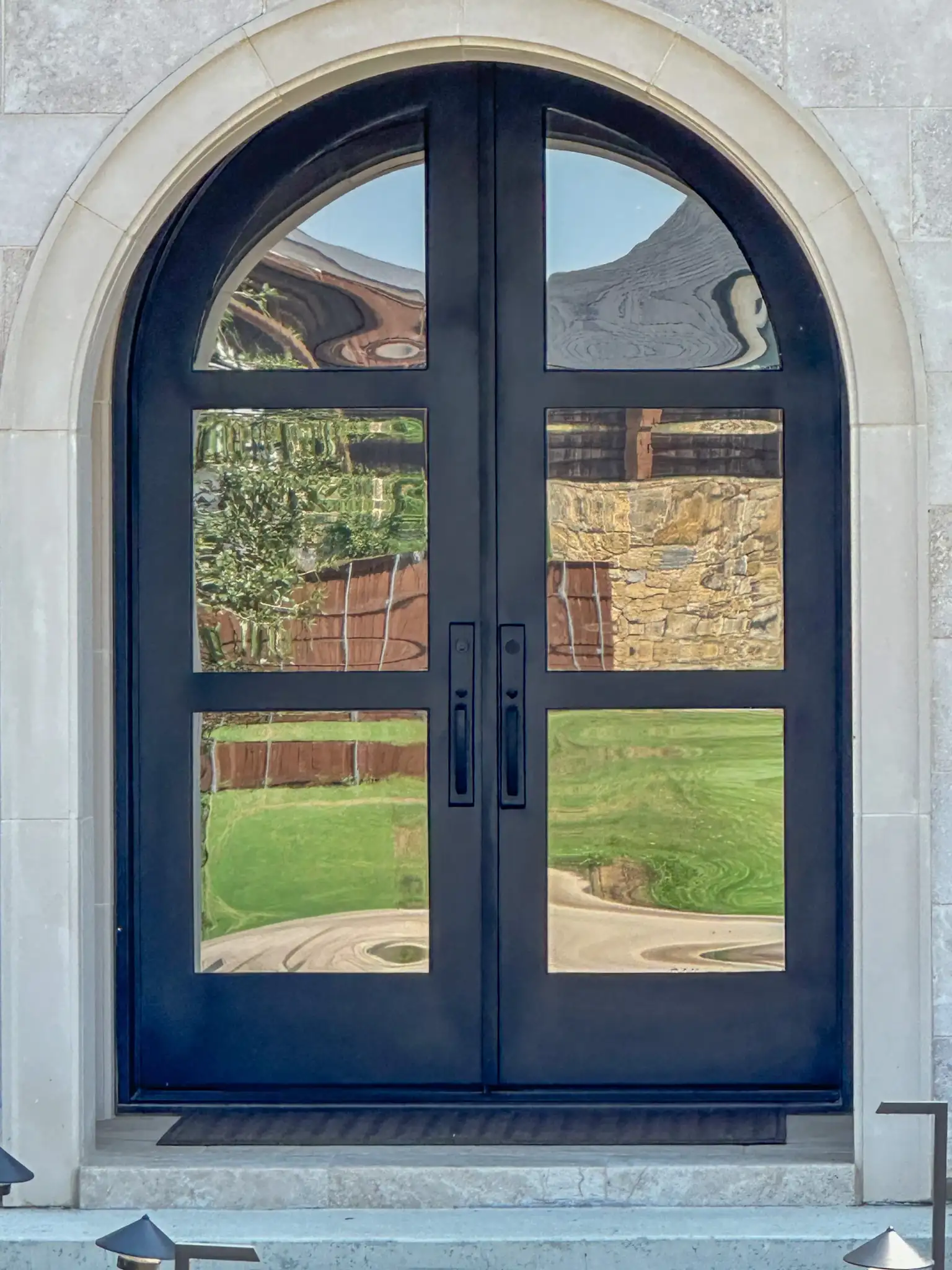 Transitional iron double doors with a full radius on a Dallas-Fort Worth home