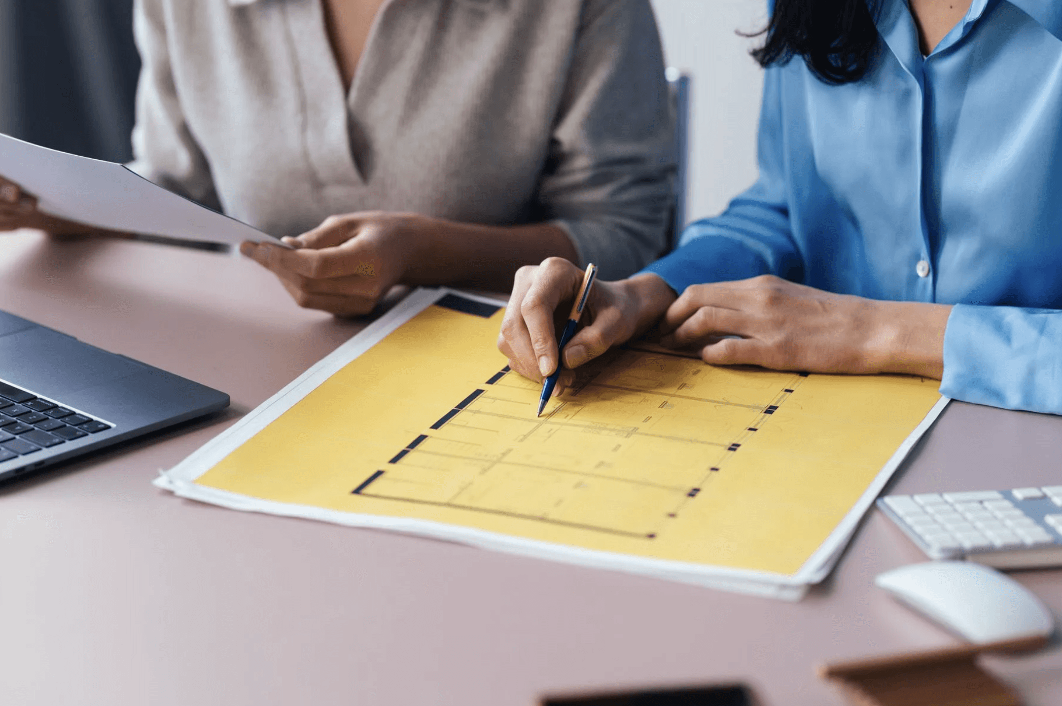 woman holding a phone and man looking at the phone. both are smiling