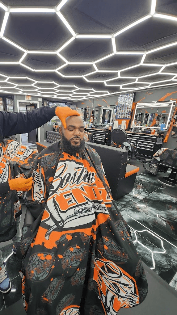 Barber cutting persons hair