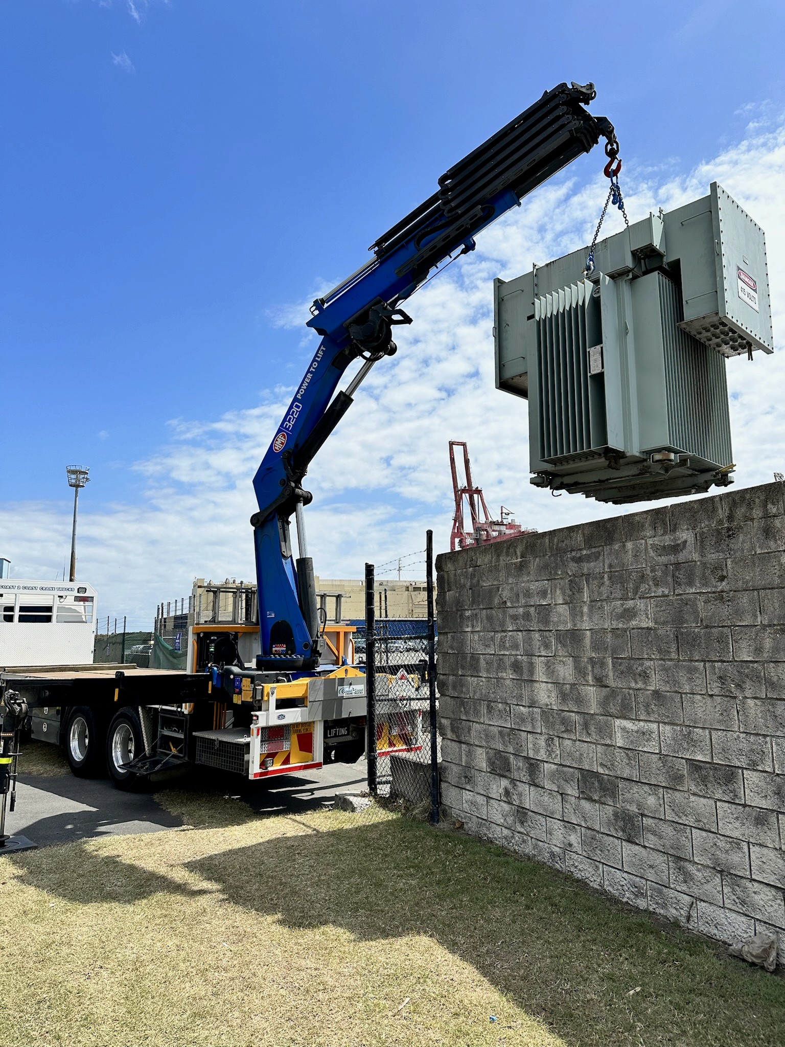 Crane truck lifting a generator