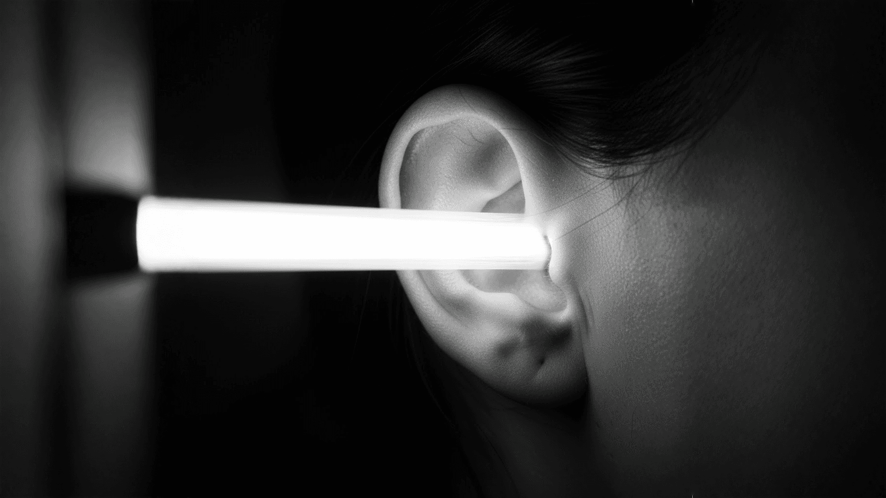 Surreal human ear receiving a structured beam of light