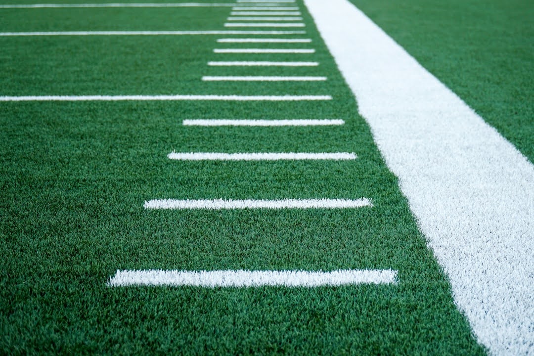 A football field featuring white lines on vibrant green grass, symbolizing the iconic play by Dwight Clark in Super Bowl XVI.