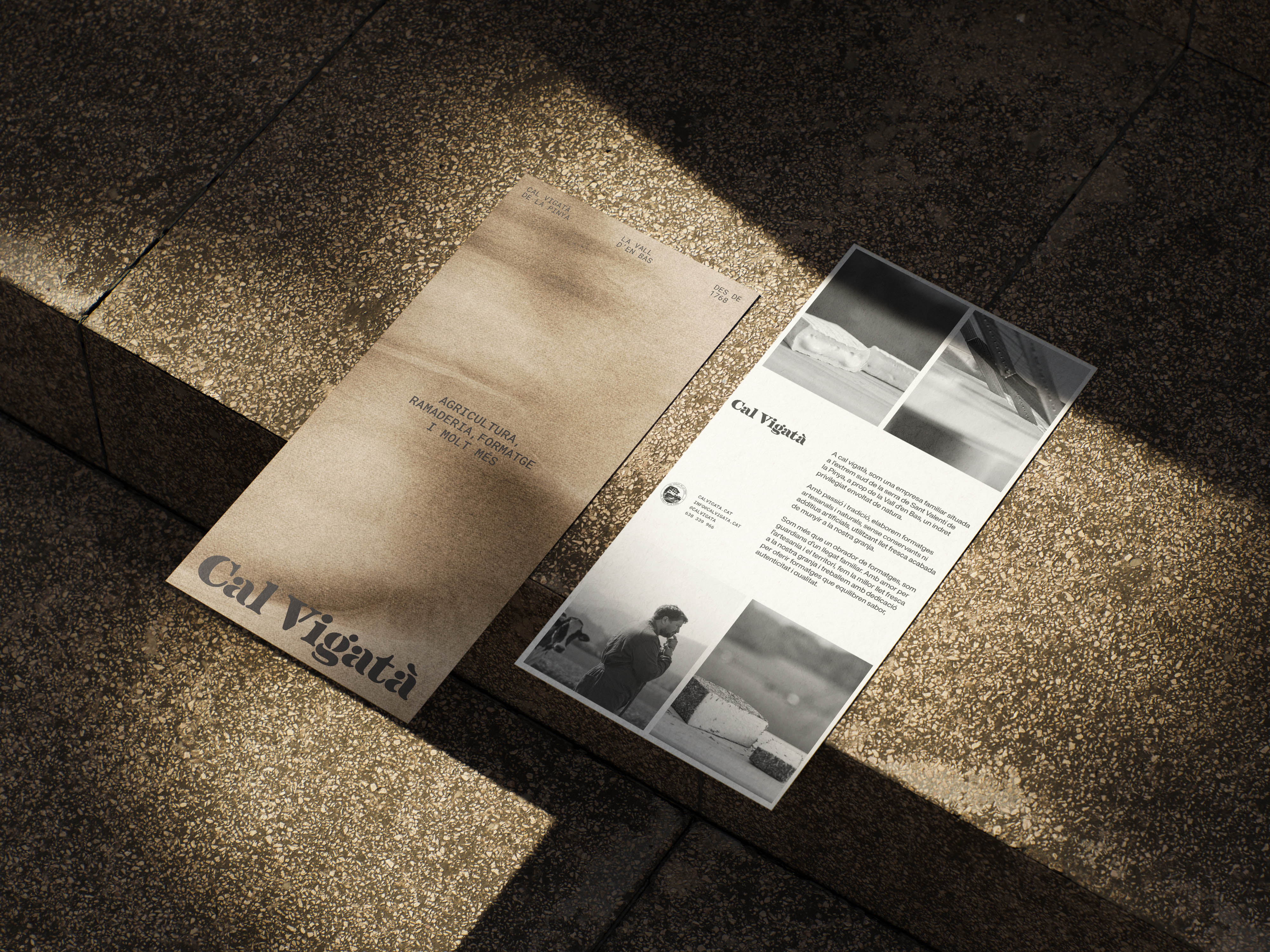 Editorial flyers placed on stone steps, showcasing the brand's logo, descriptive text, and black-and-white photography of rural farm life.