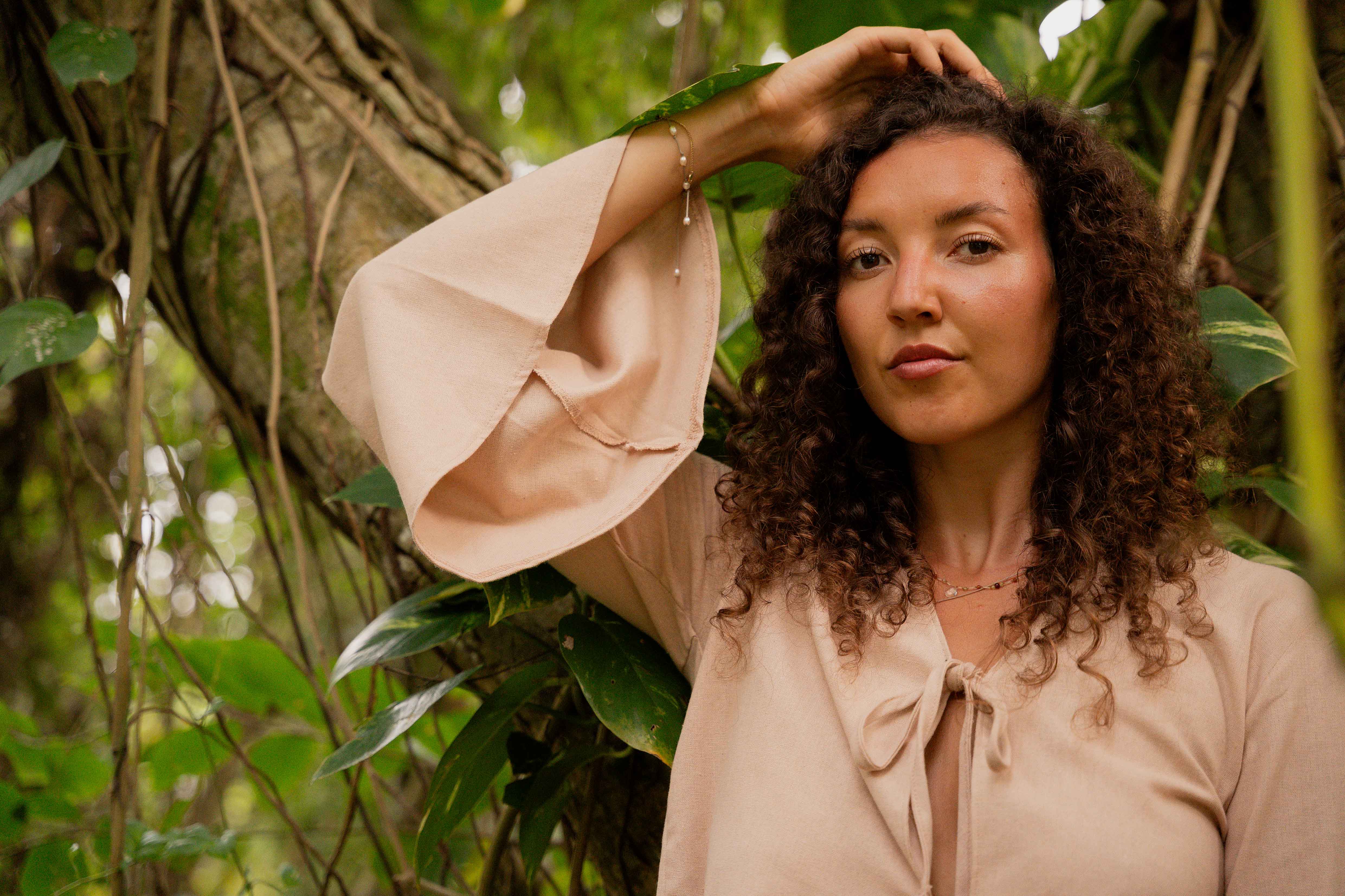 Girl posing on a tree looking into the camera