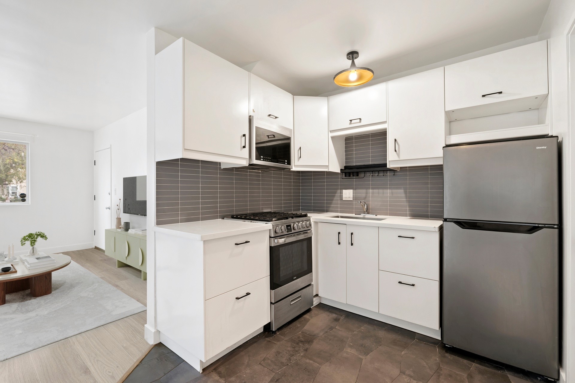 200 N Rampart renovated kitchen with white cabinetry, gray tile backsplash and stainless appliances.