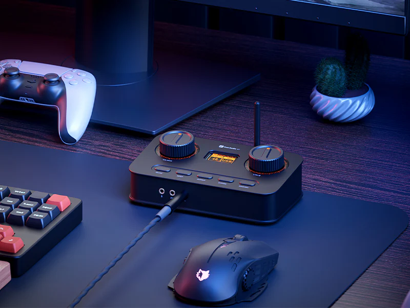 Audio interface on desk next to mouse and controller