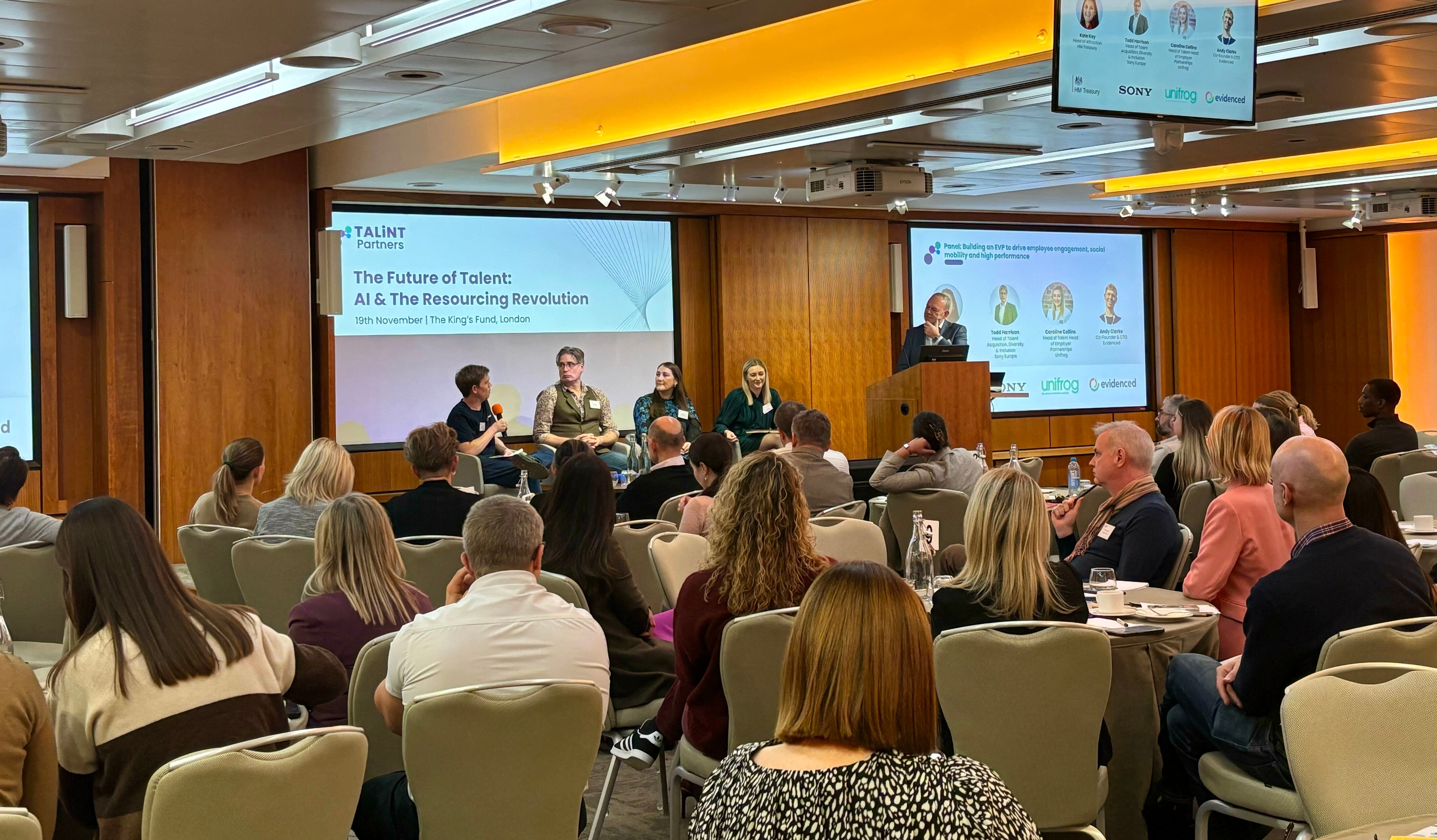 Panel conversation and man at a lecturn in a busy conference room 
