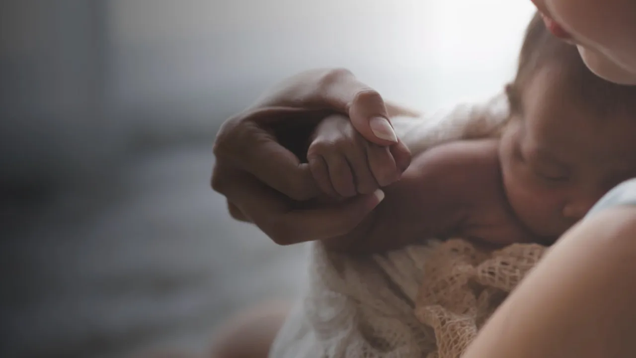 Woman with her new born baby in her arms representing Flouria’s Postpartum care