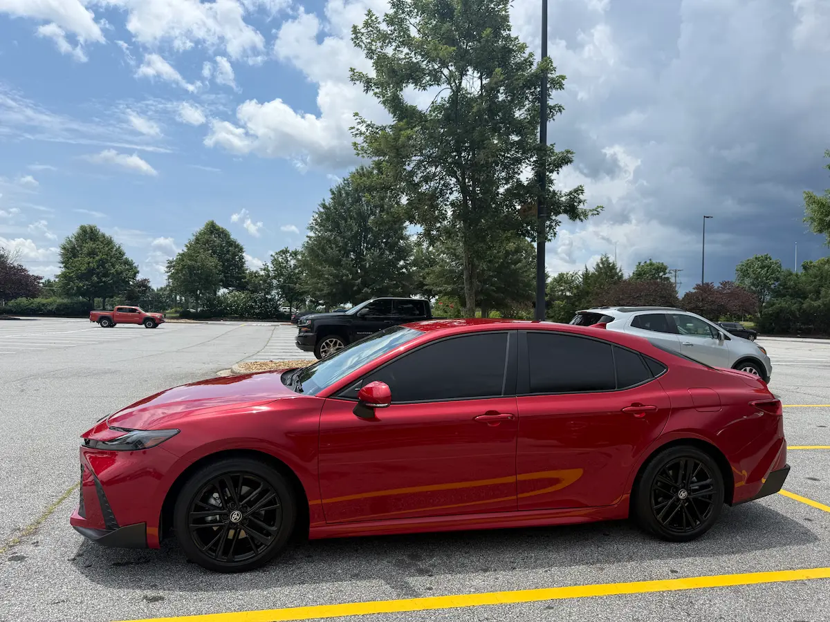 Red 2026 Toyota Camry parked in a lot on a sunny day, showing a fresh start and a new chapter.