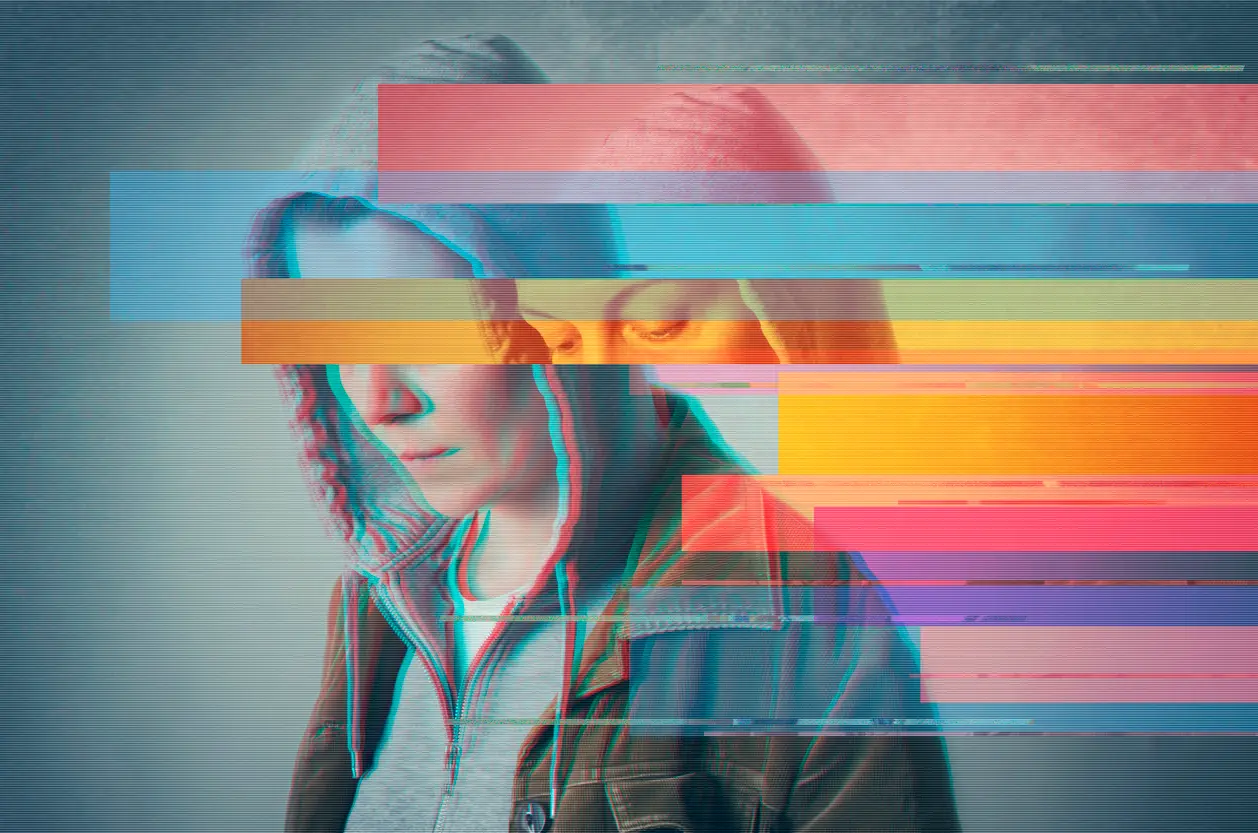Hooded young person with digital glitch distortion overlay, illustrating the psychological fragmentation that precedes radicalisation