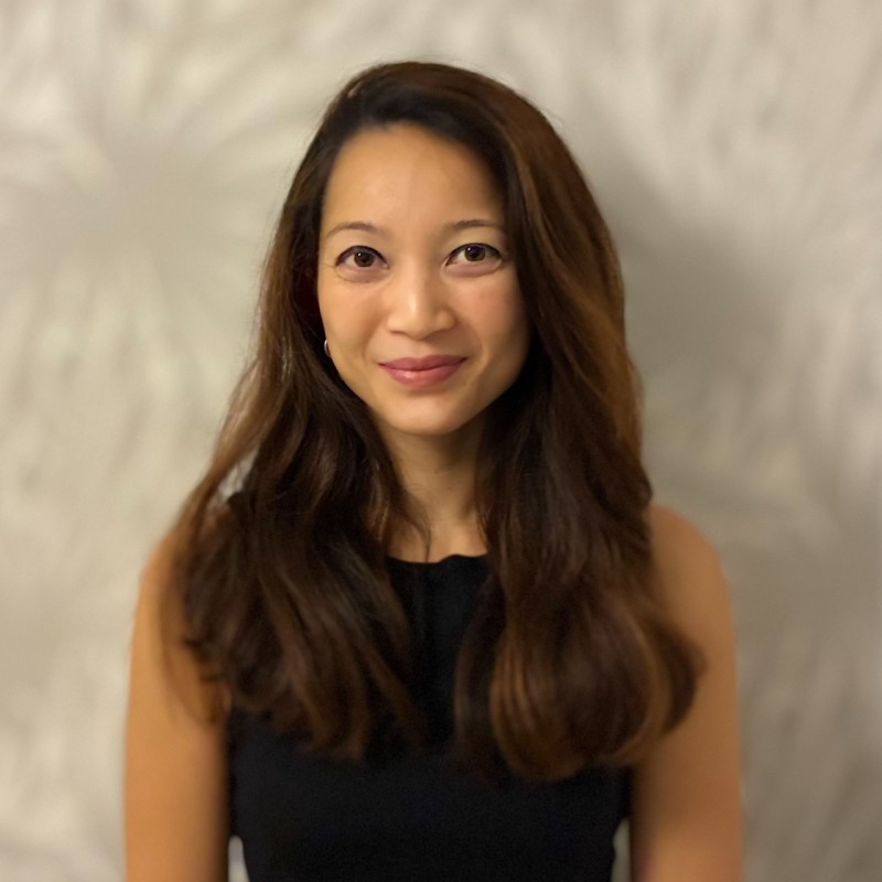 woman in black long sleeve shirt sitting on white couch
