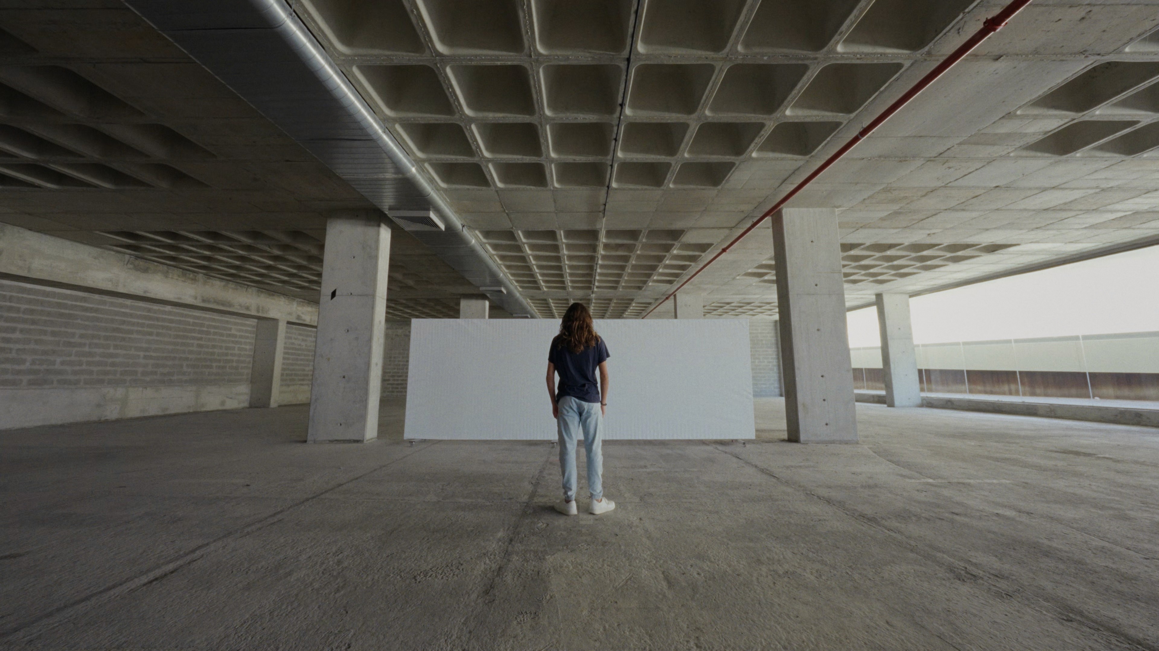 a young man stares into an empty canvas in a frame from Life Among Worlds