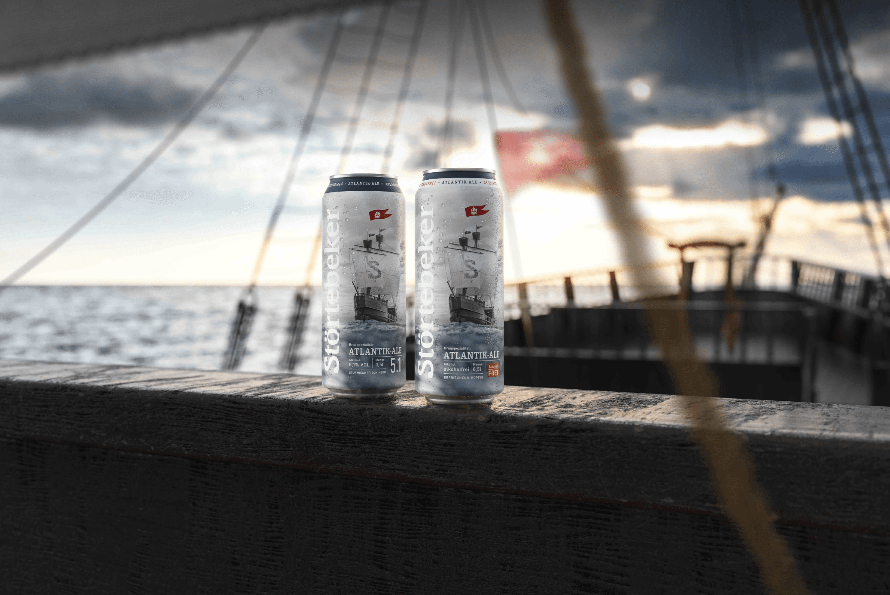 Two Störtebeker Atlantik Ale cans on a wooden surface.