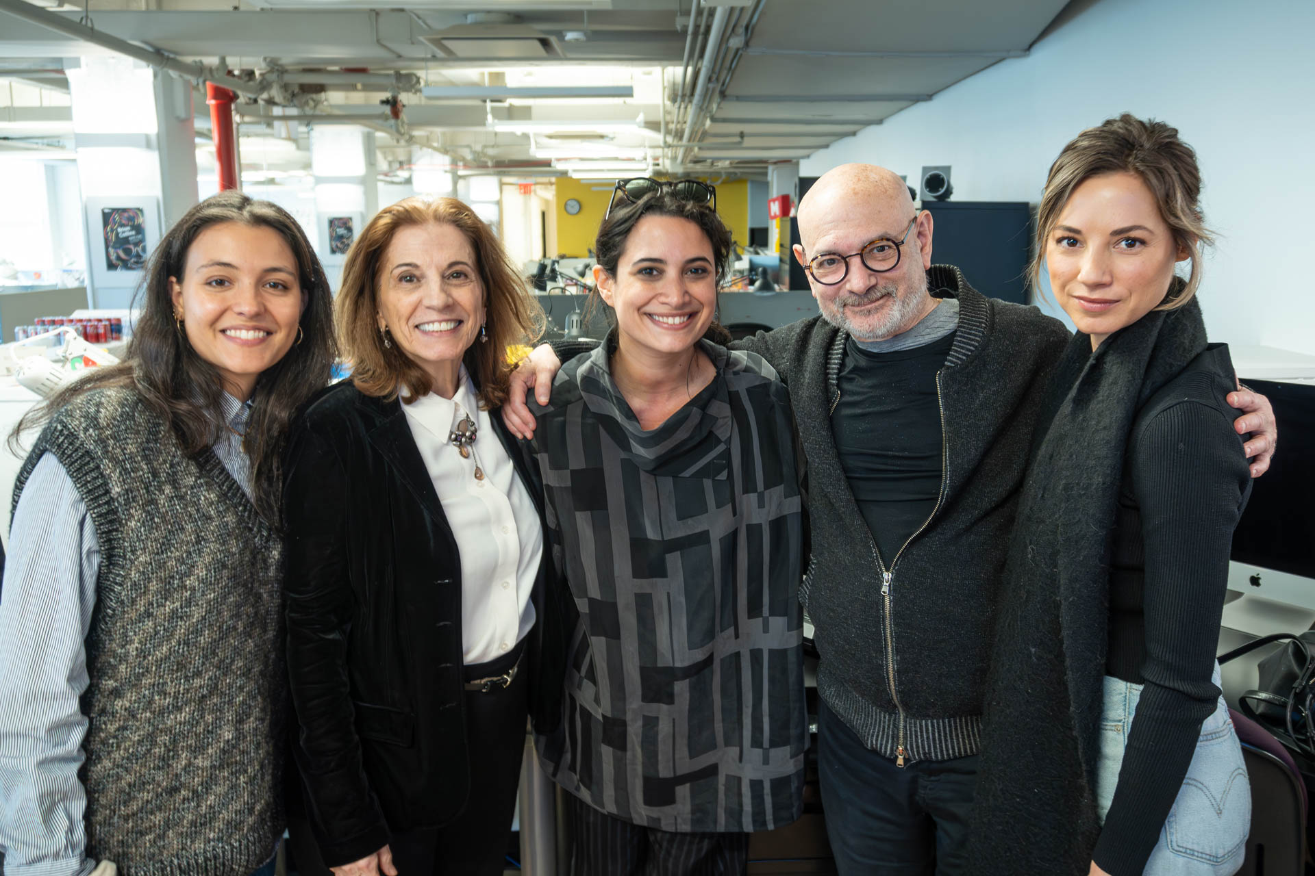 a group of 5 people posing for camera