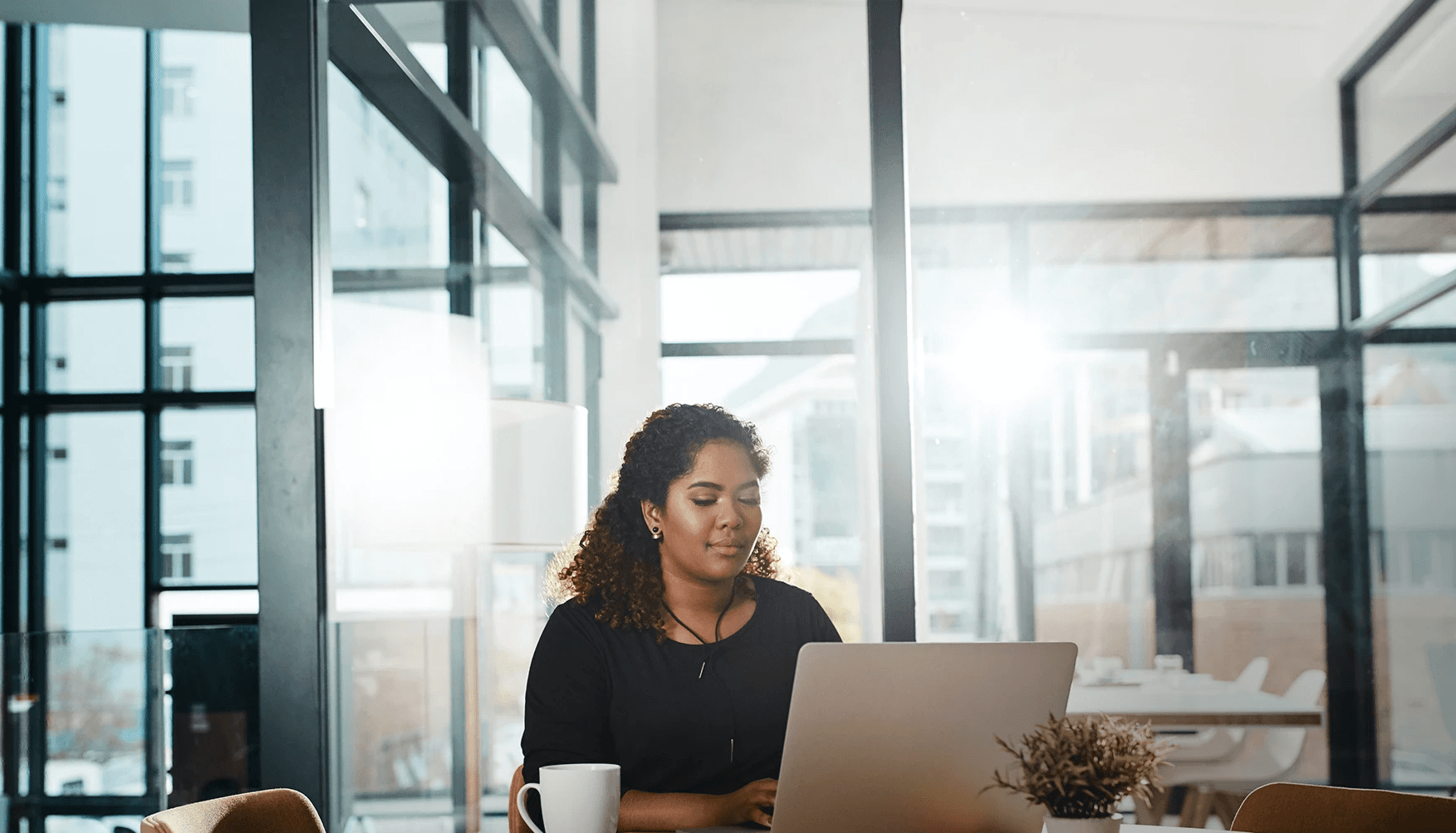 Woman working on a laptop, representing business insurance solutions from We Insure Downtown Miami.