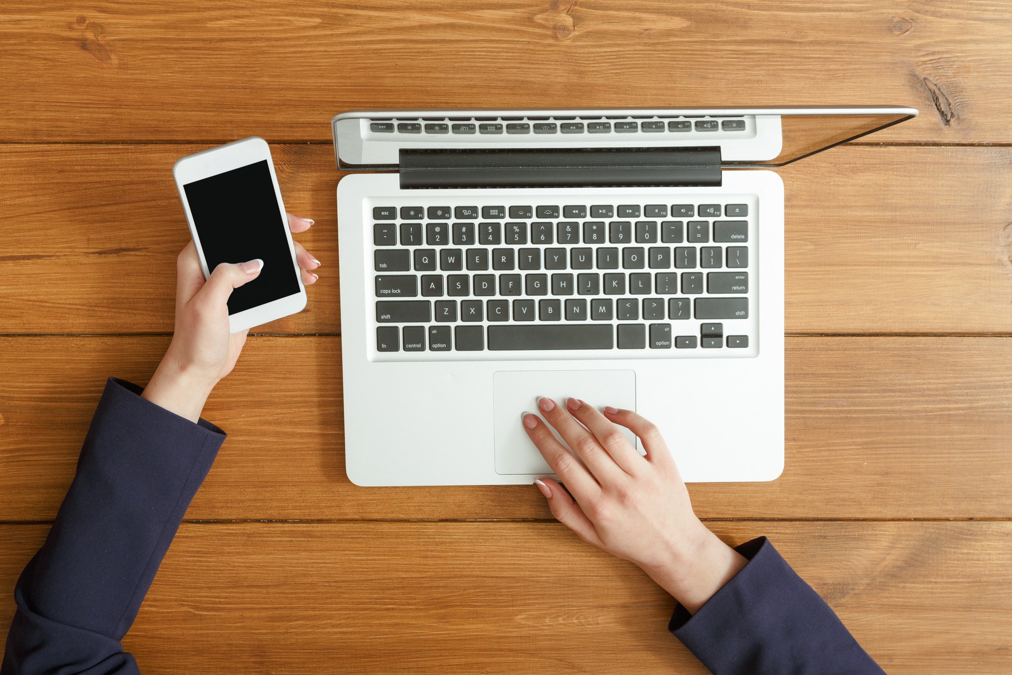 Businesswoman Hands with Laptop and Smartphone on Desk
