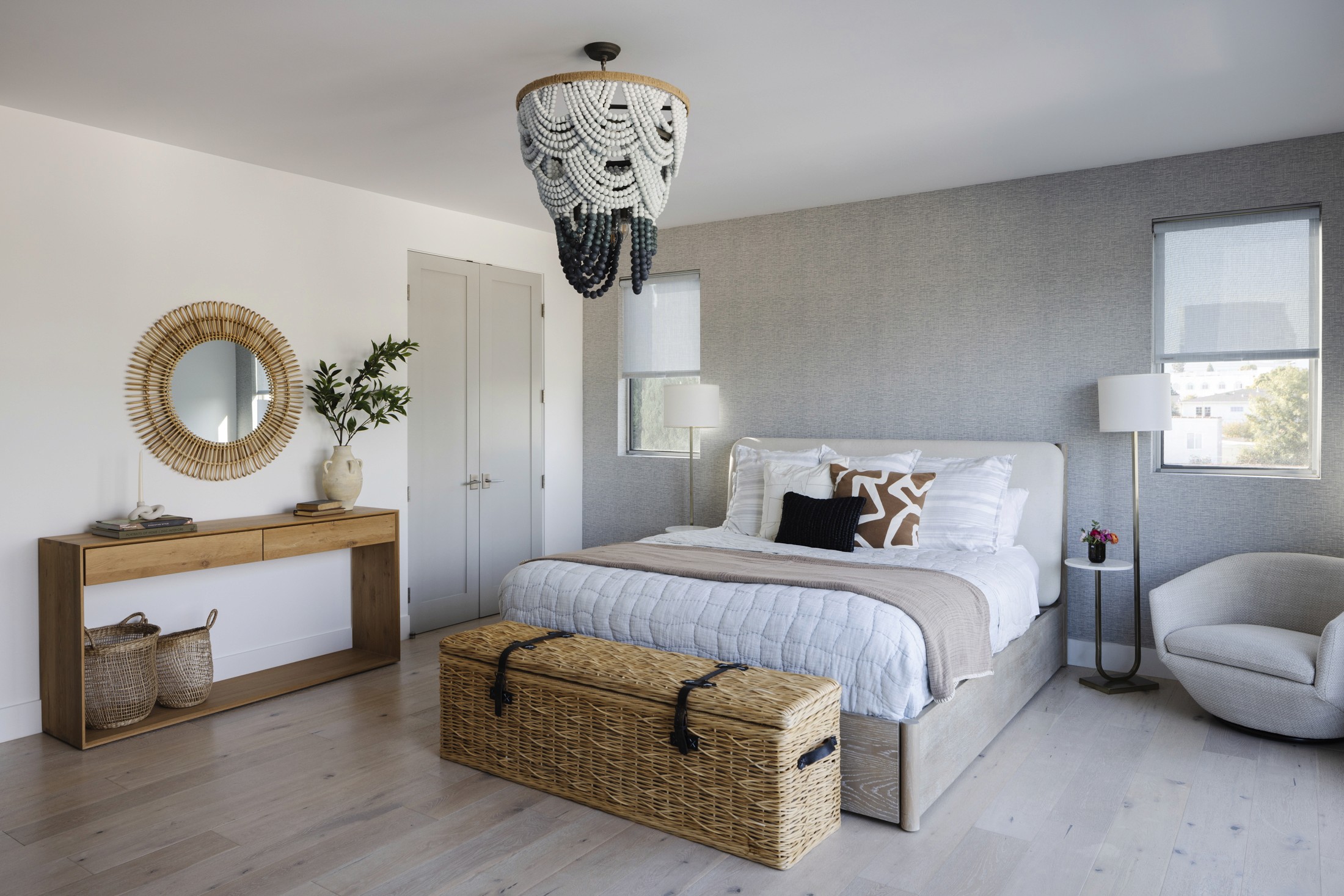 Primary bedroom view of bed, console table, accent chair, and large chandelier lighting