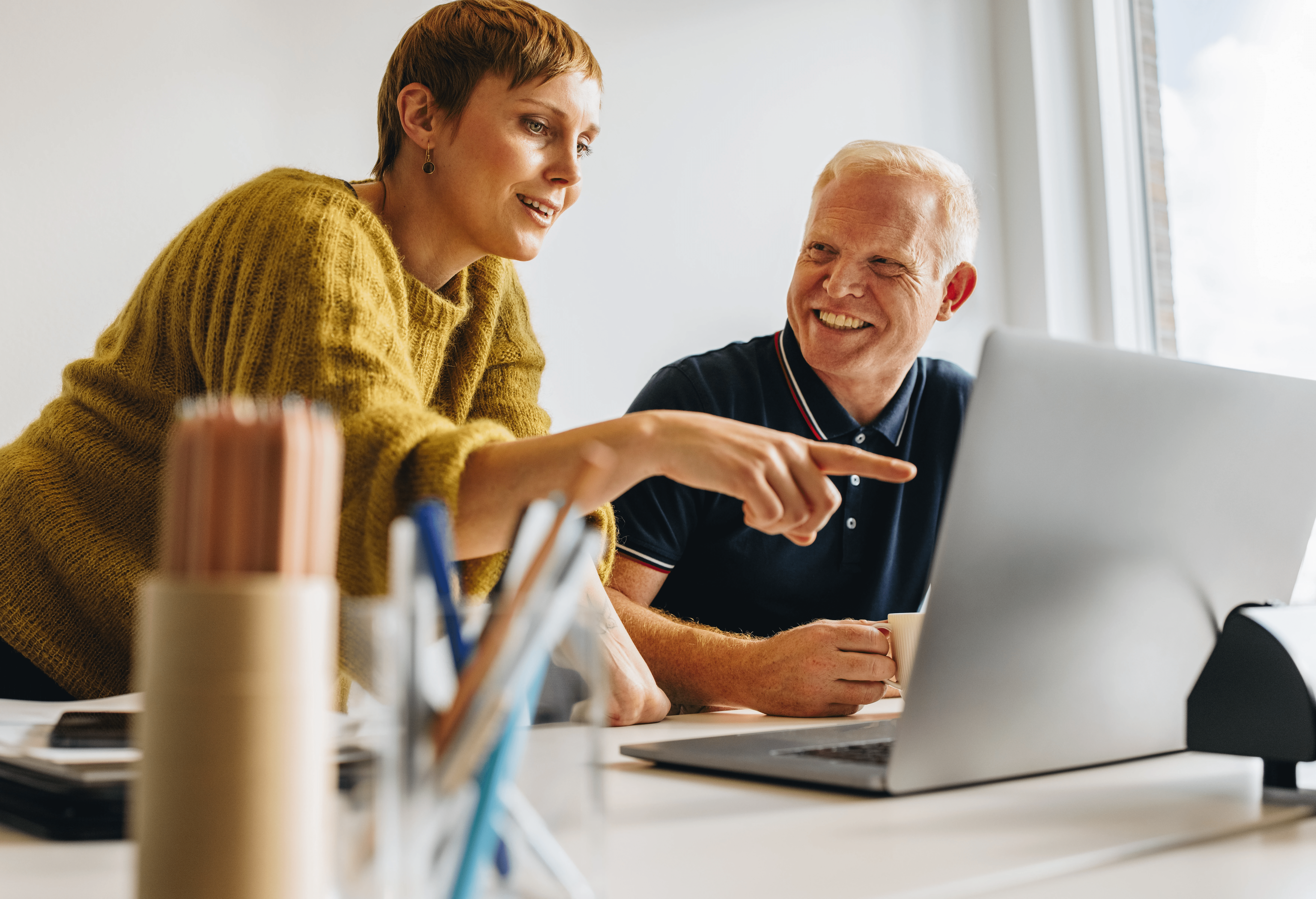 Man and woman working on laptop