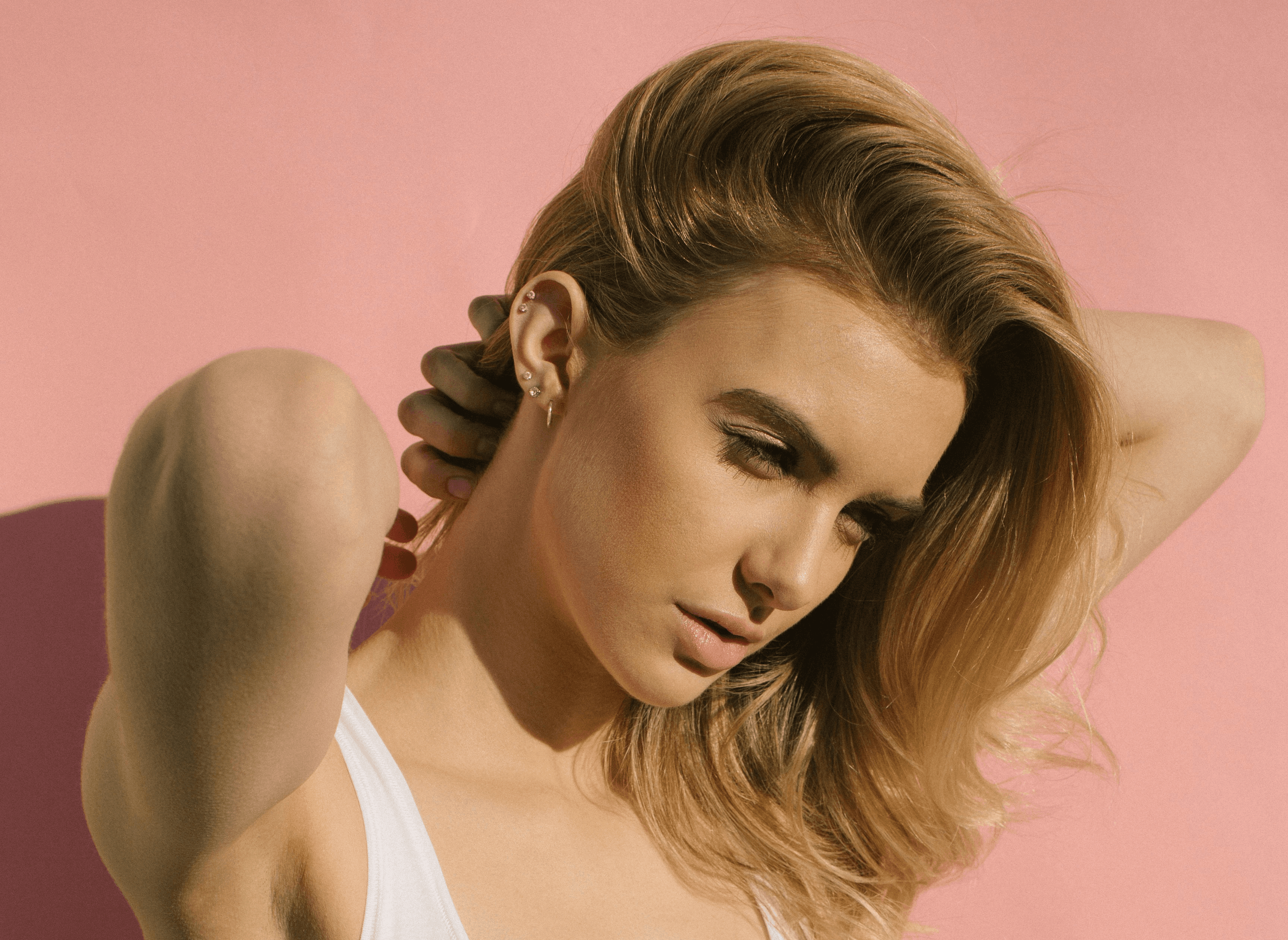 woman in white training bra scratching her back