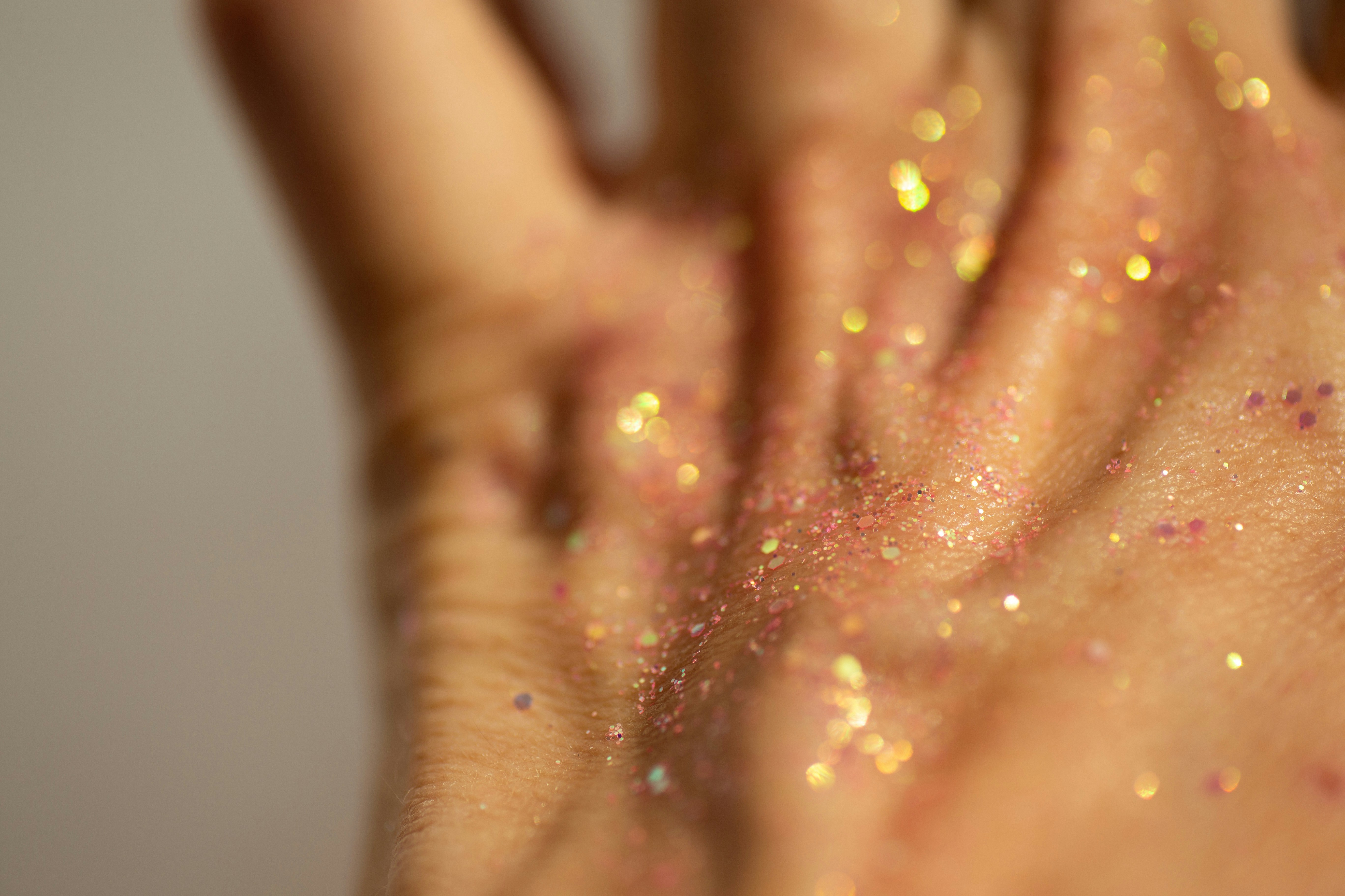 Close-up of a hand covered in glitter