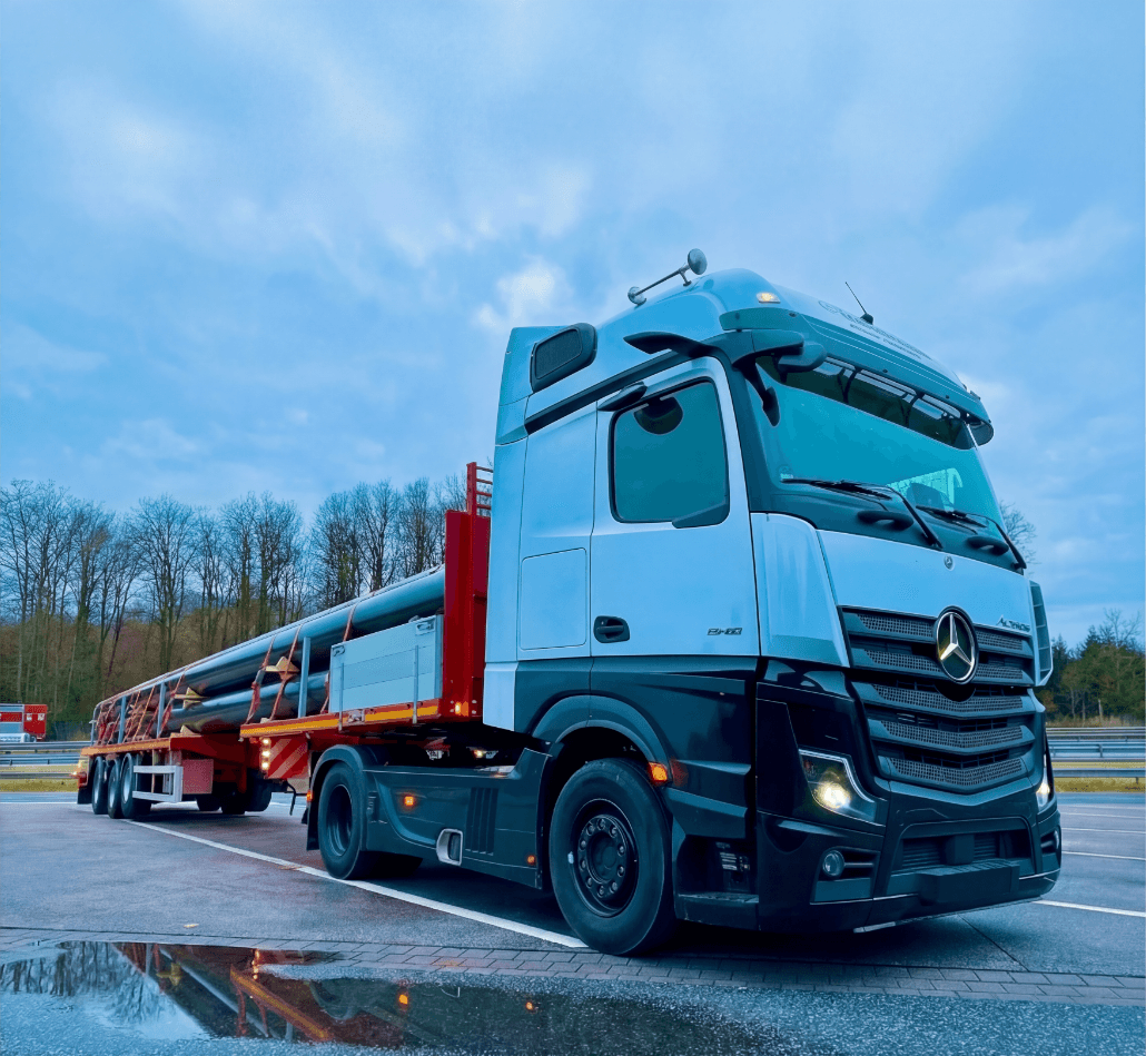 man wearing maroon V-neck t-shirt in forest